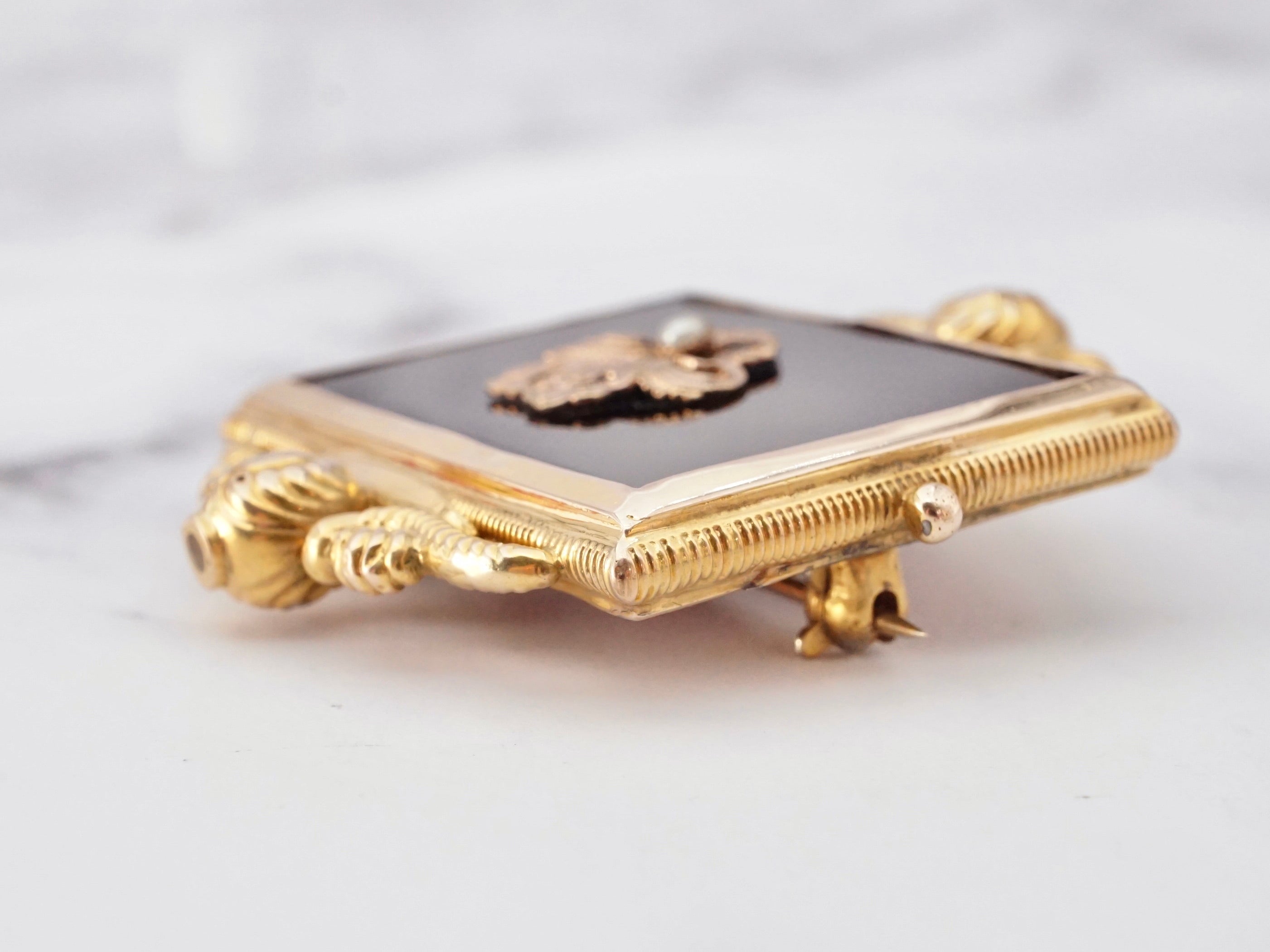 Antique Victorian 10k gold, onyx, and pearl mourning frame brooch