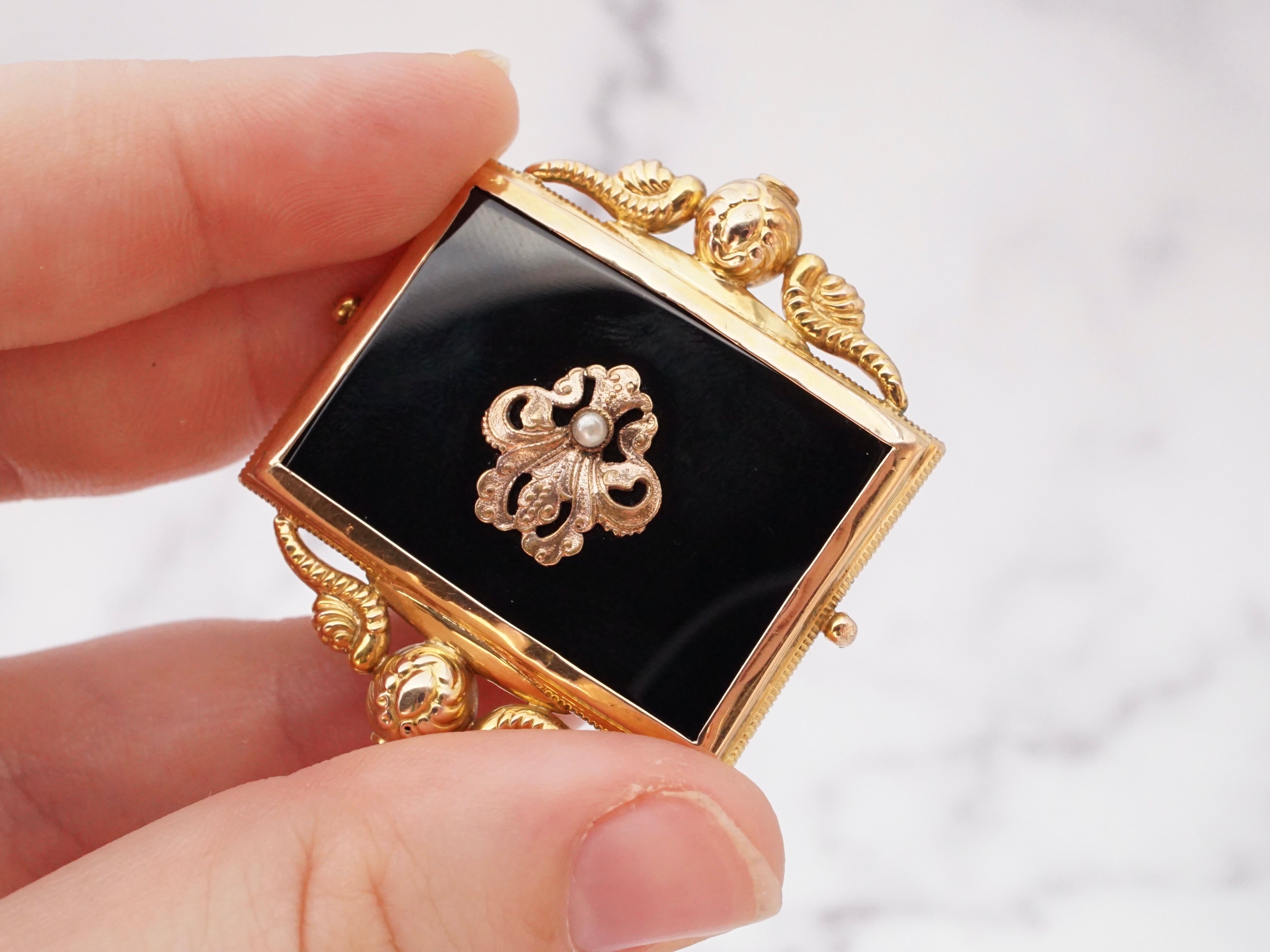 Antique Victorian 10k gold, onyx, and pearl mourning frame brooch