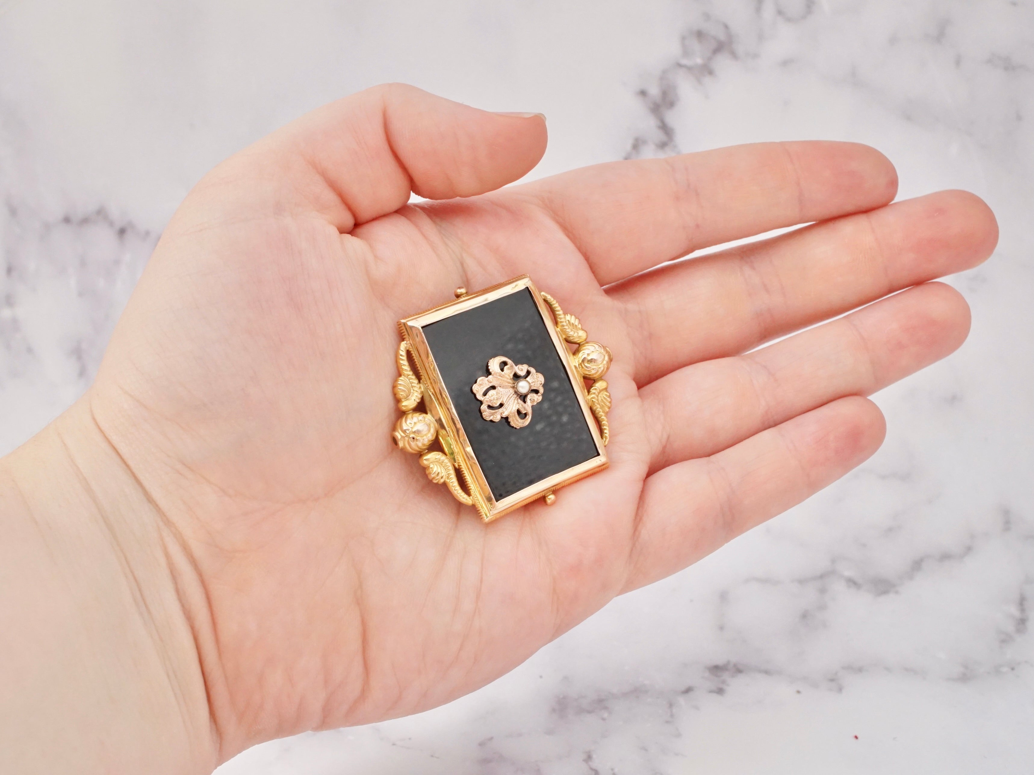 Antique Victorian 10k gold, onyx, and pearl mourning frame brooch