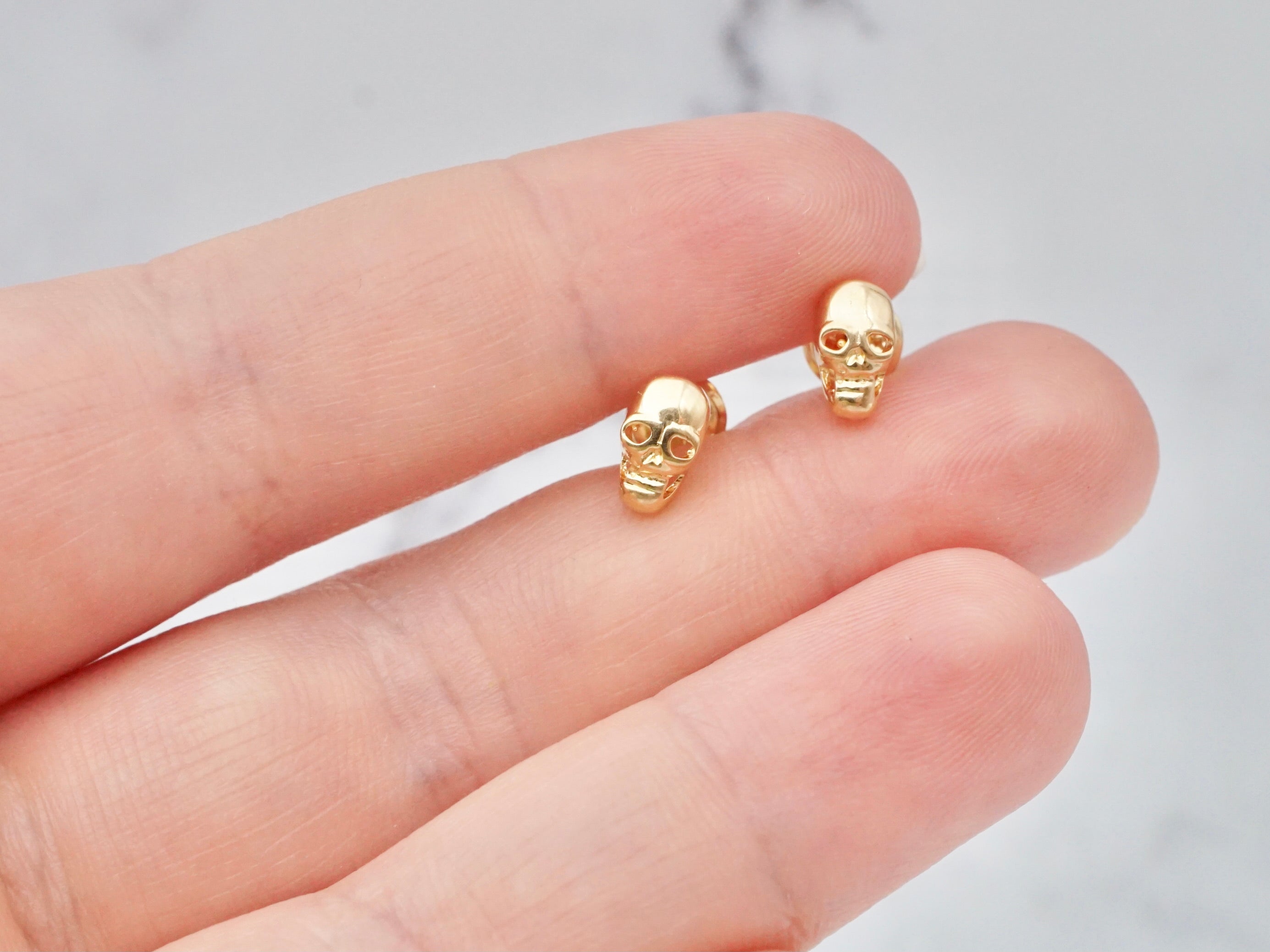 Tiny vintage 14k gold skull studs