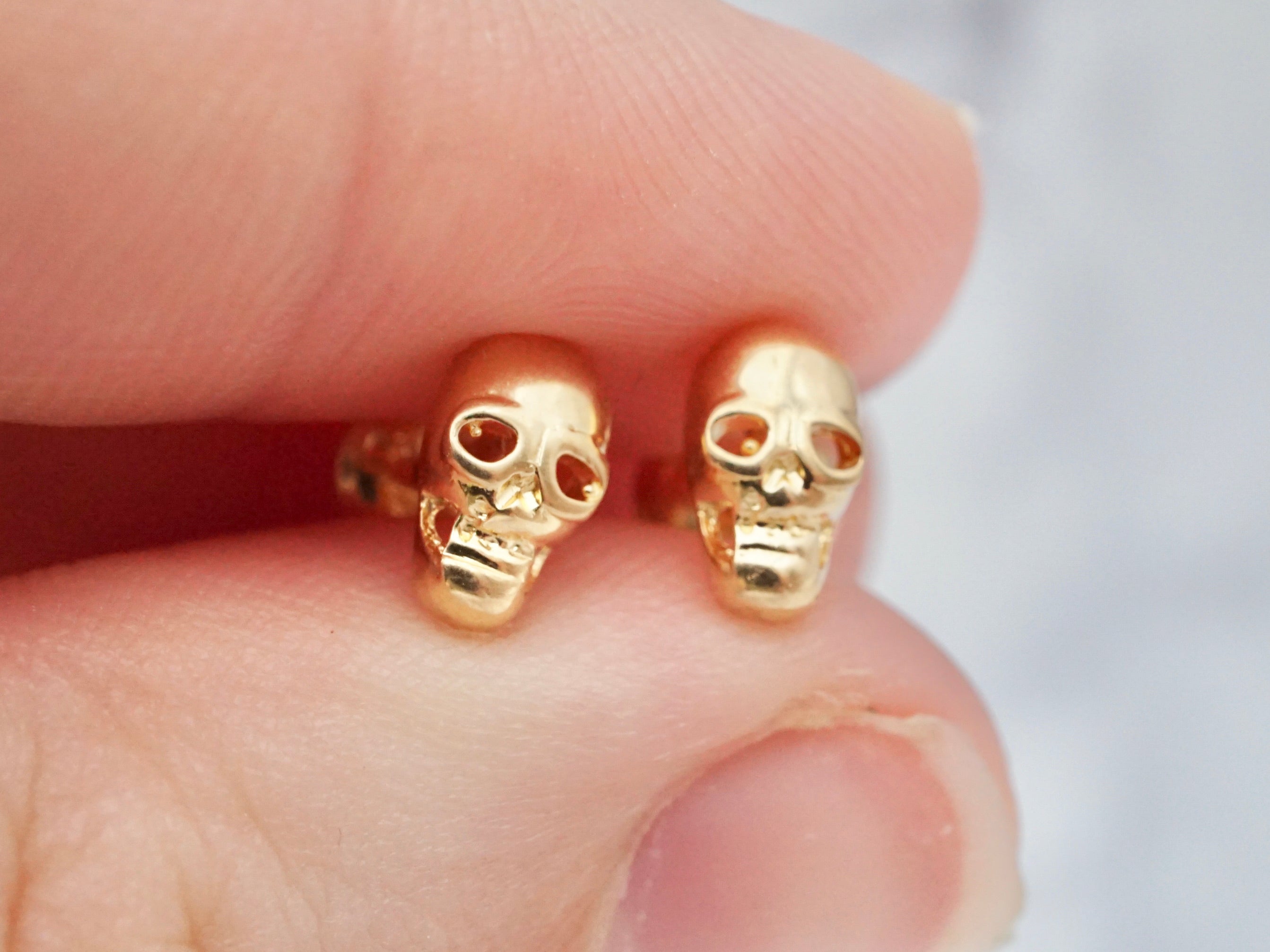 Tiny vintage 14k gold skull studs