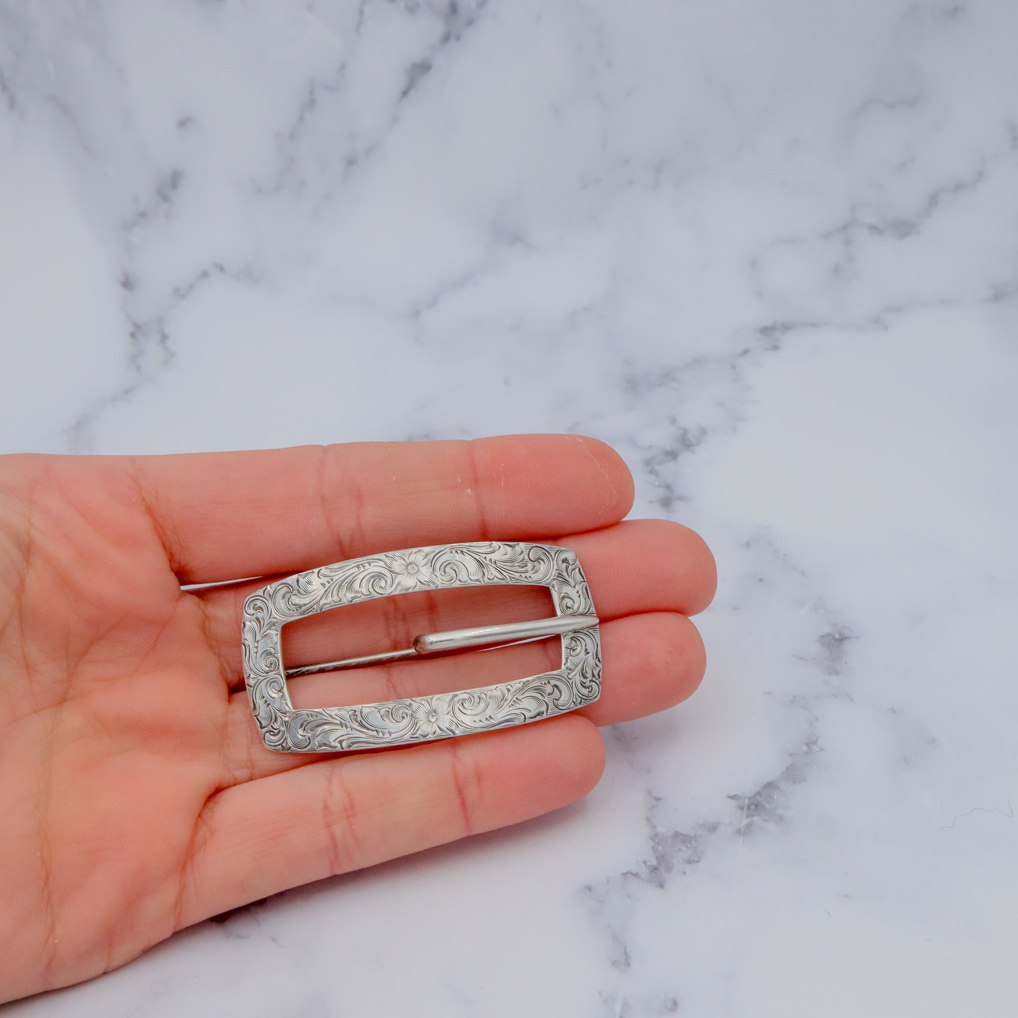 Pair of Antique bright cut engraved sterling Unger Brothers buckle brooches