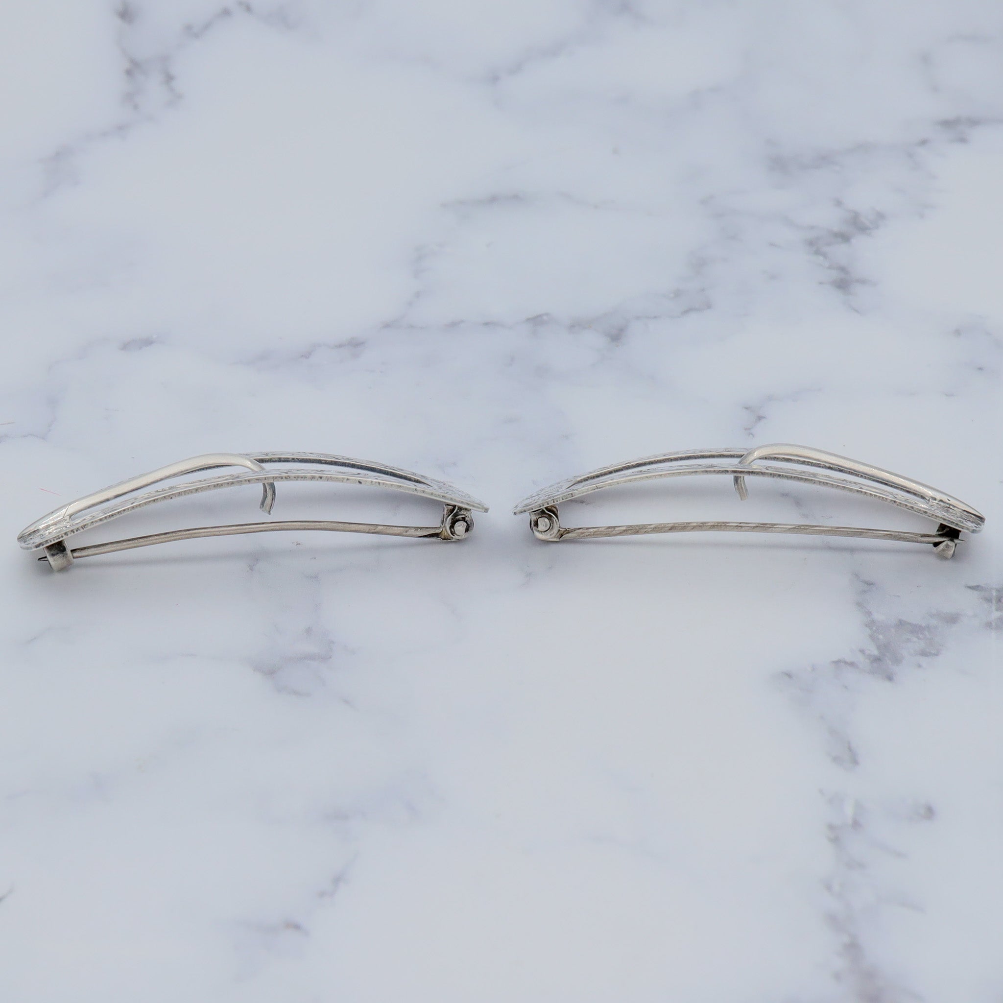 Pair of Antique bright cut engraved sterling Unger Brothers buckle brooches