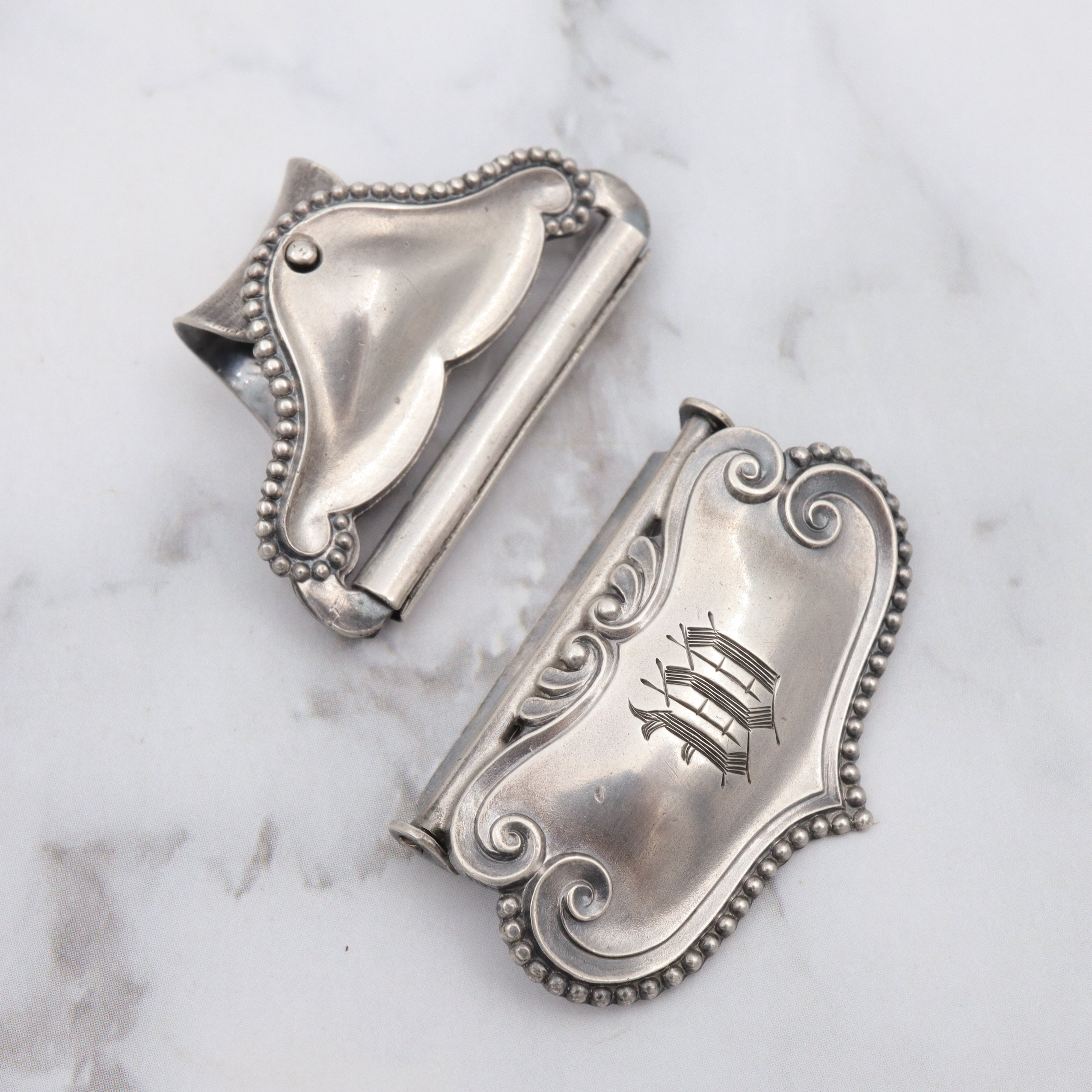 Pair of Antique sterling suspender buckle clips by Sloan & Co.