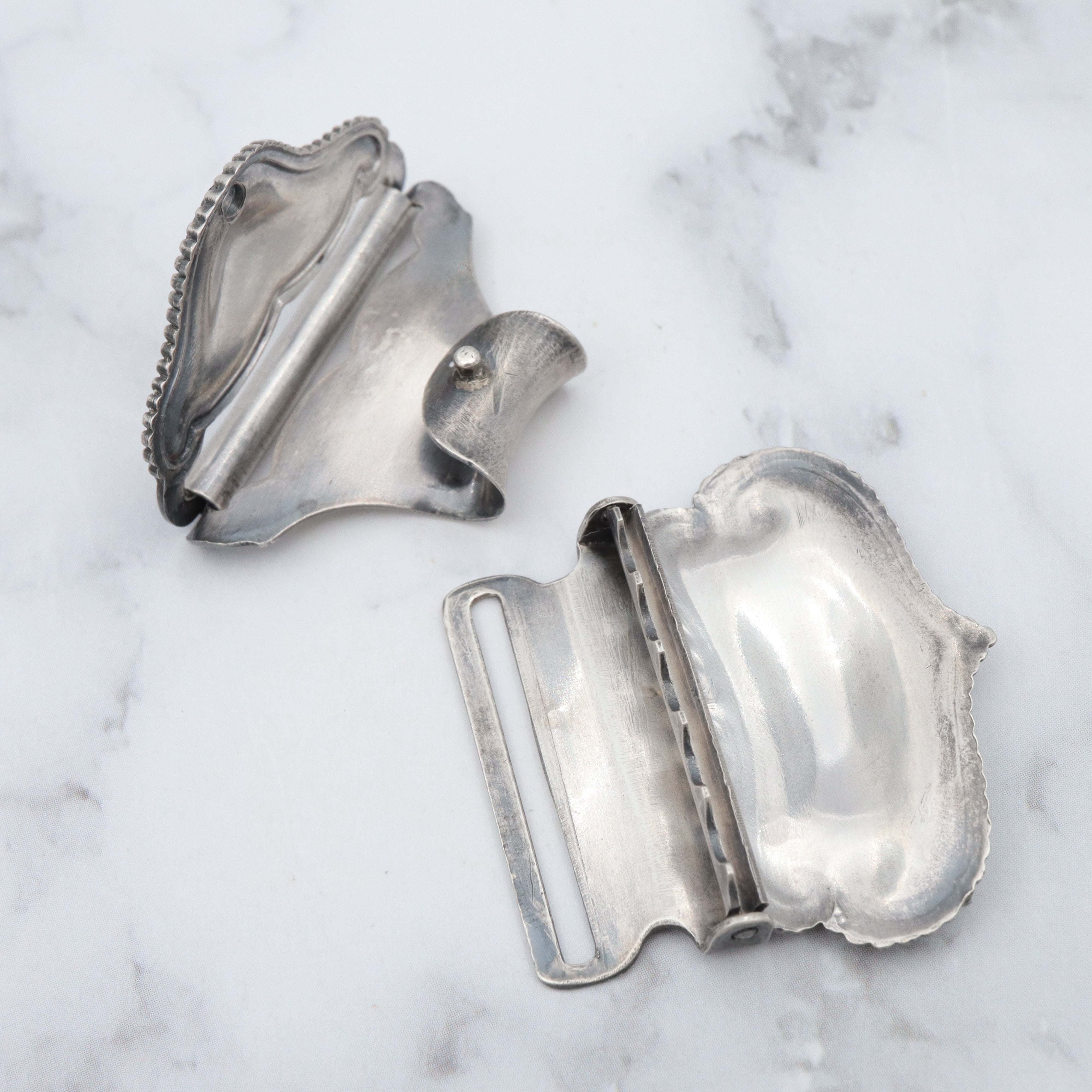 Pair of Antique sterling suspender buckle clips by Sloan & Co.
