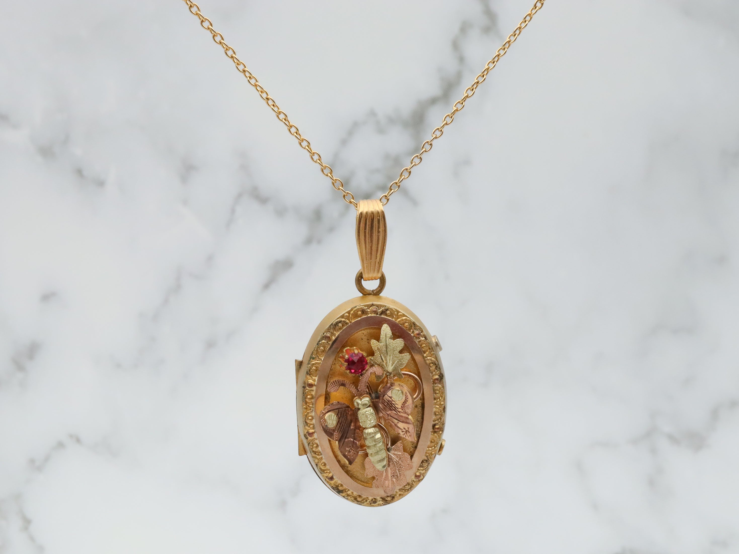 Antique Victorian two tone gold filled locket with moving butterfly