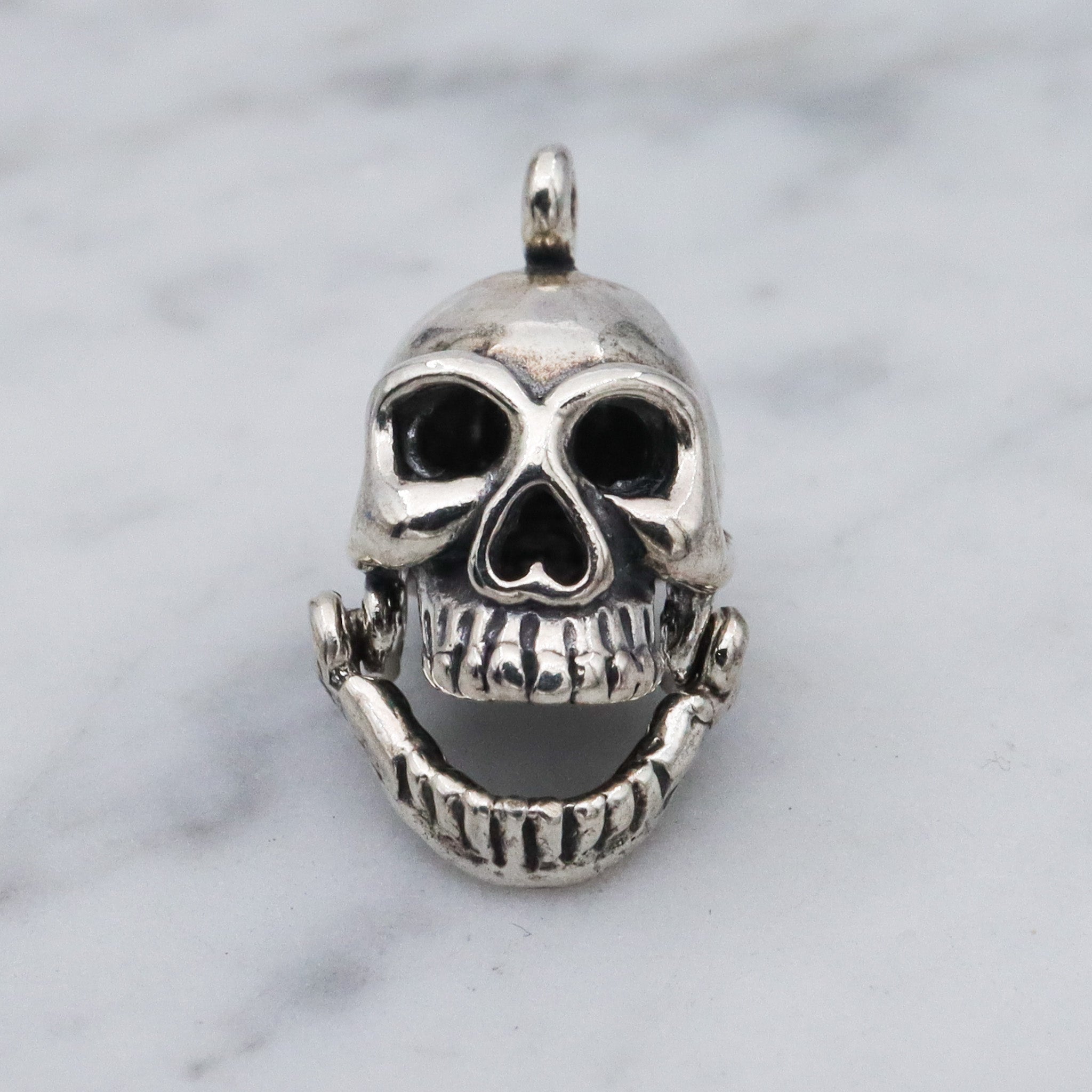 Vintage sterling silver hinged jaw skull pendants