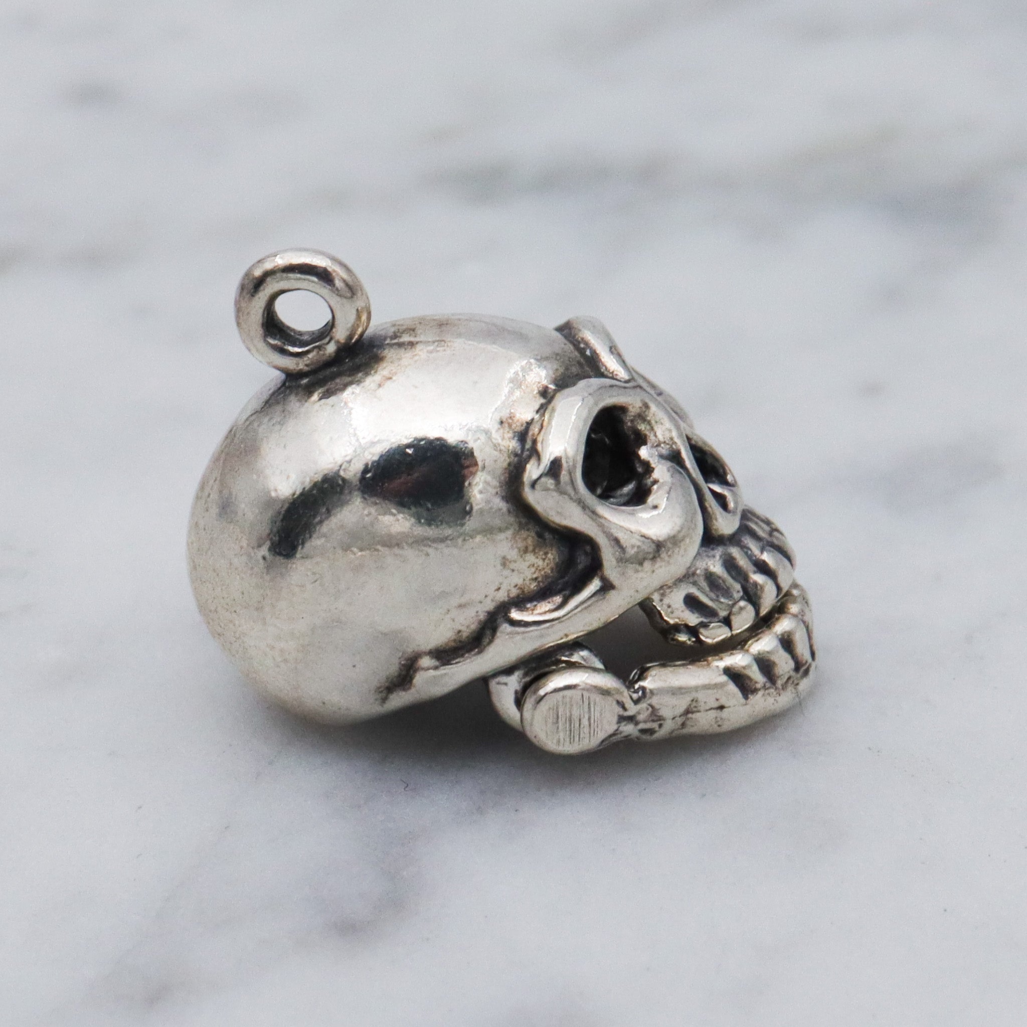 Vintage sterling silver hinged jaw skull pendants
