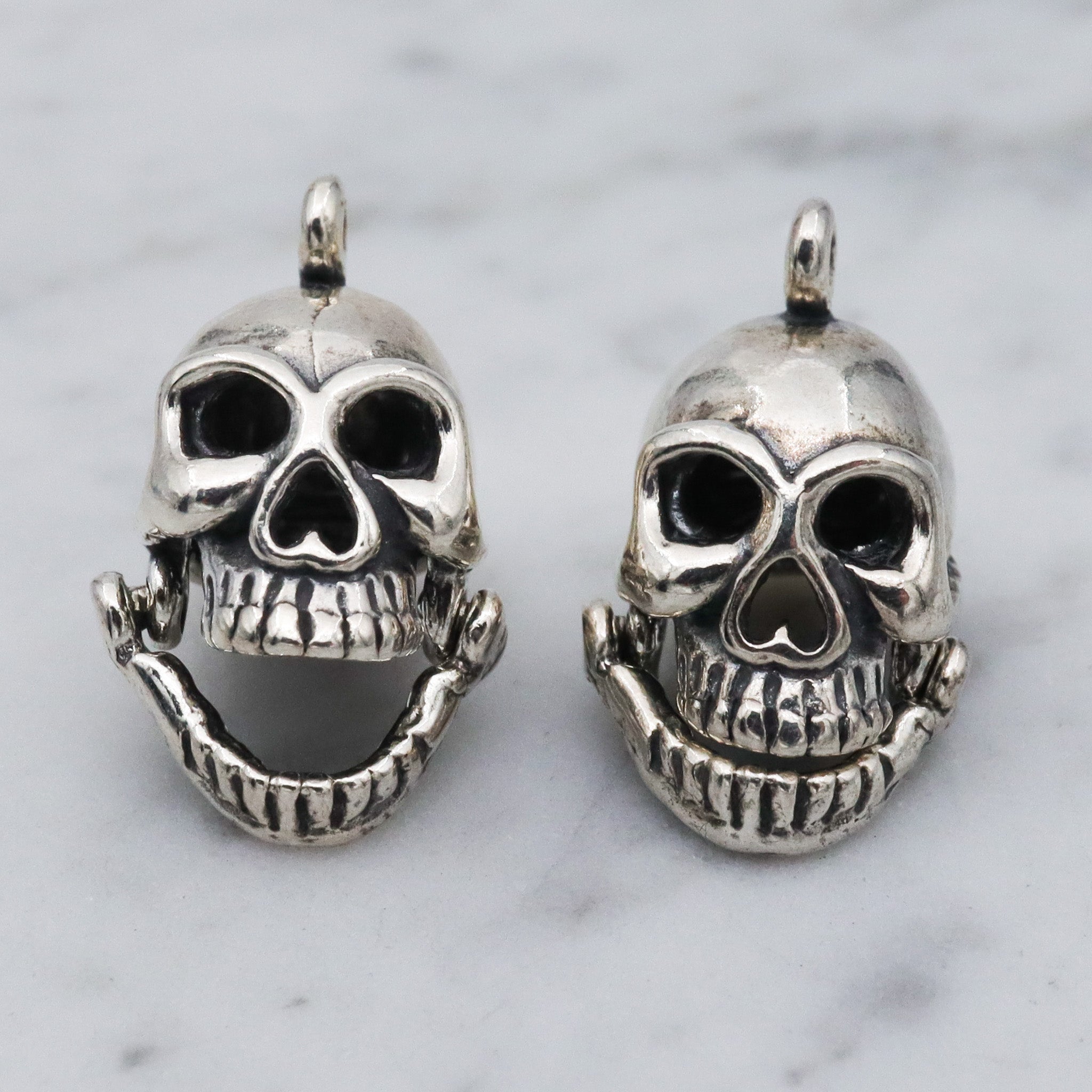 Vintage sterling silver hinged jaw skull pendants
