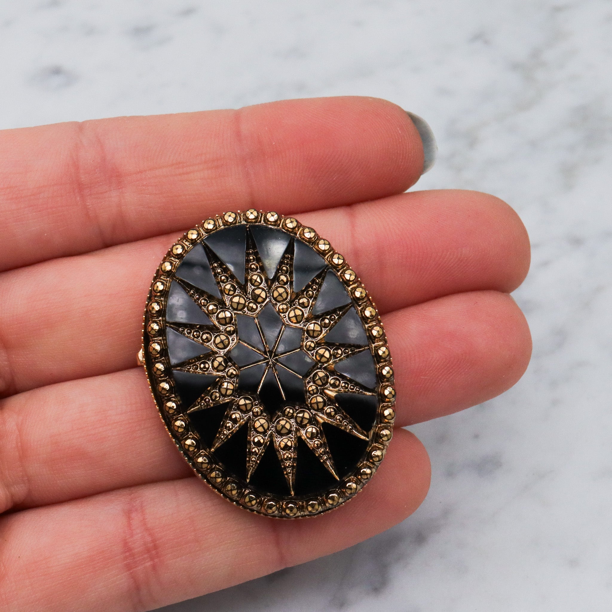 Victorian button style black glass brooch with gold sunburst