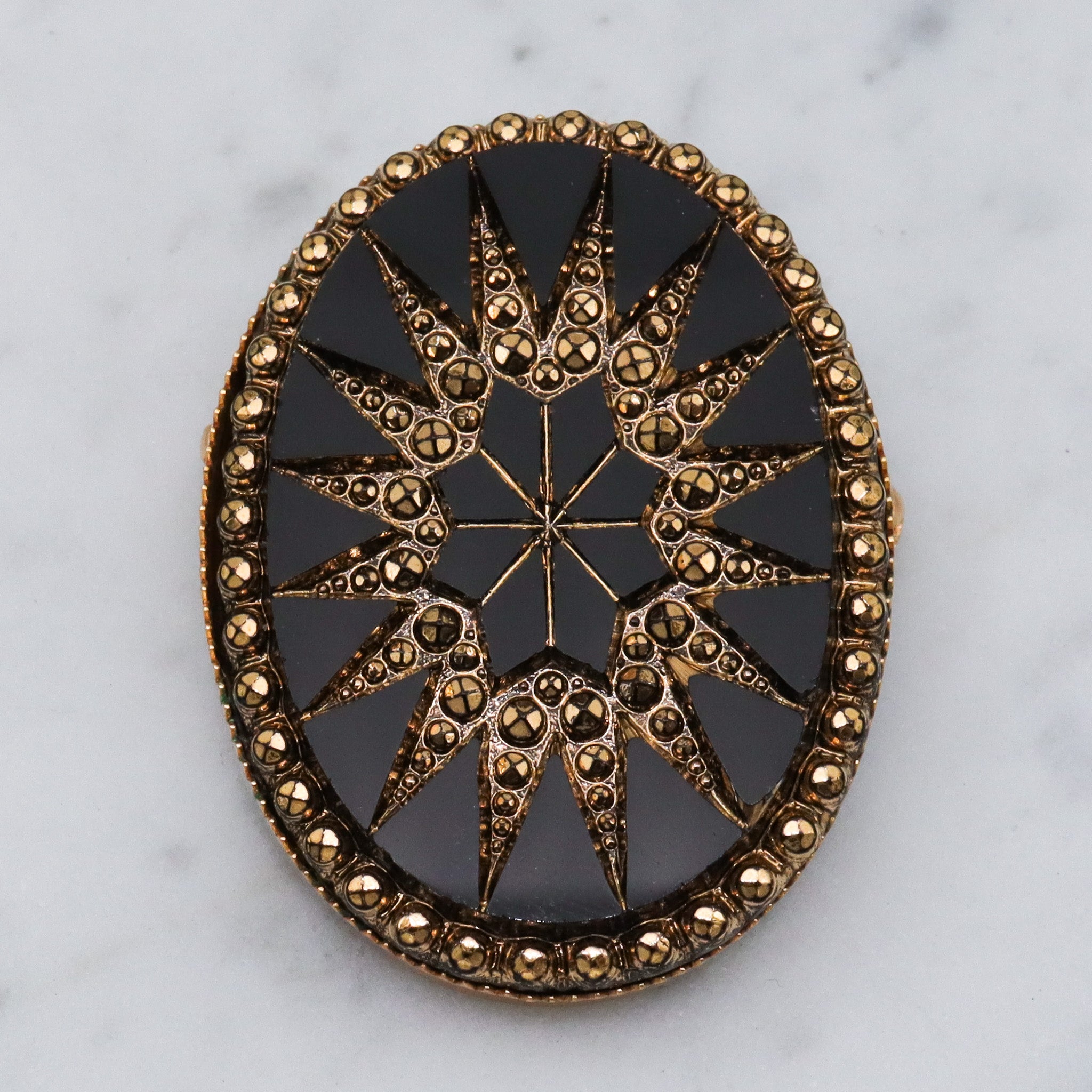 Victorian button style black glass brooch with gold sunburst