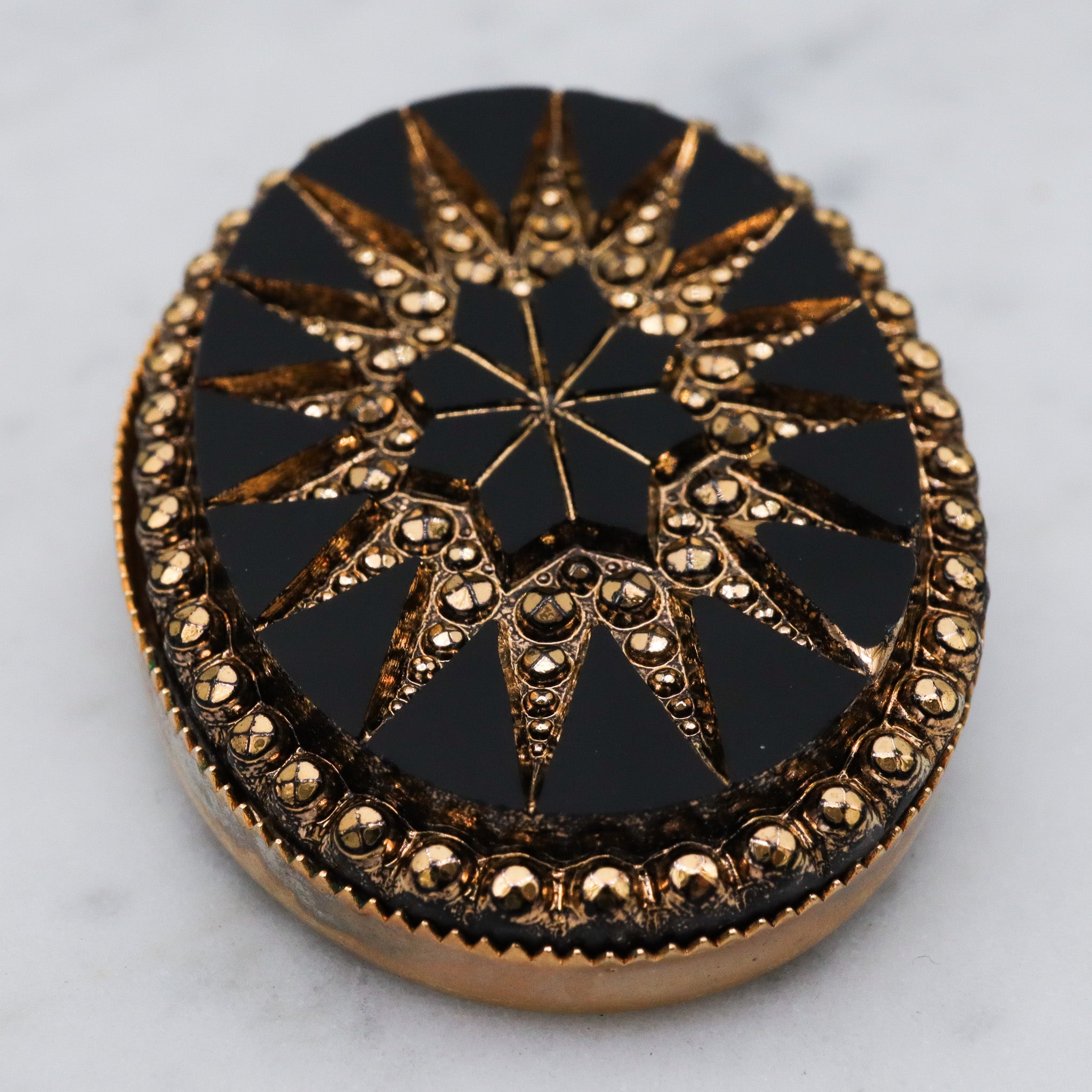 Victorian button style black glass brooch with gold sunburst