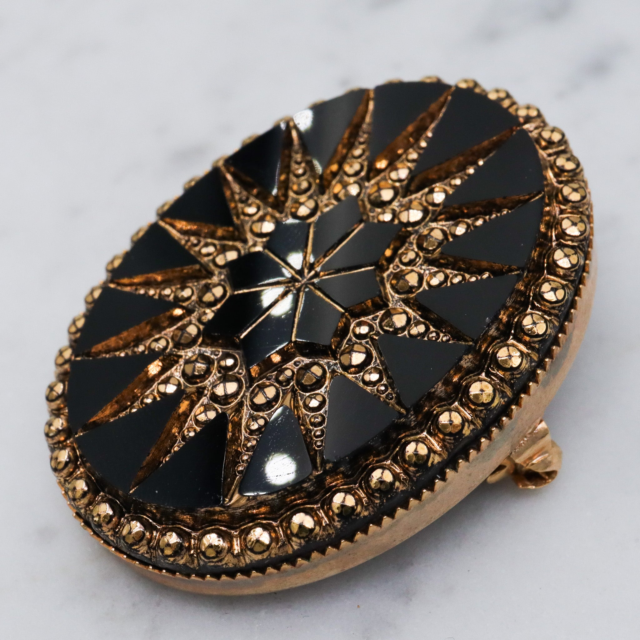 Victorian button style black glass brooch with gold sunburst
