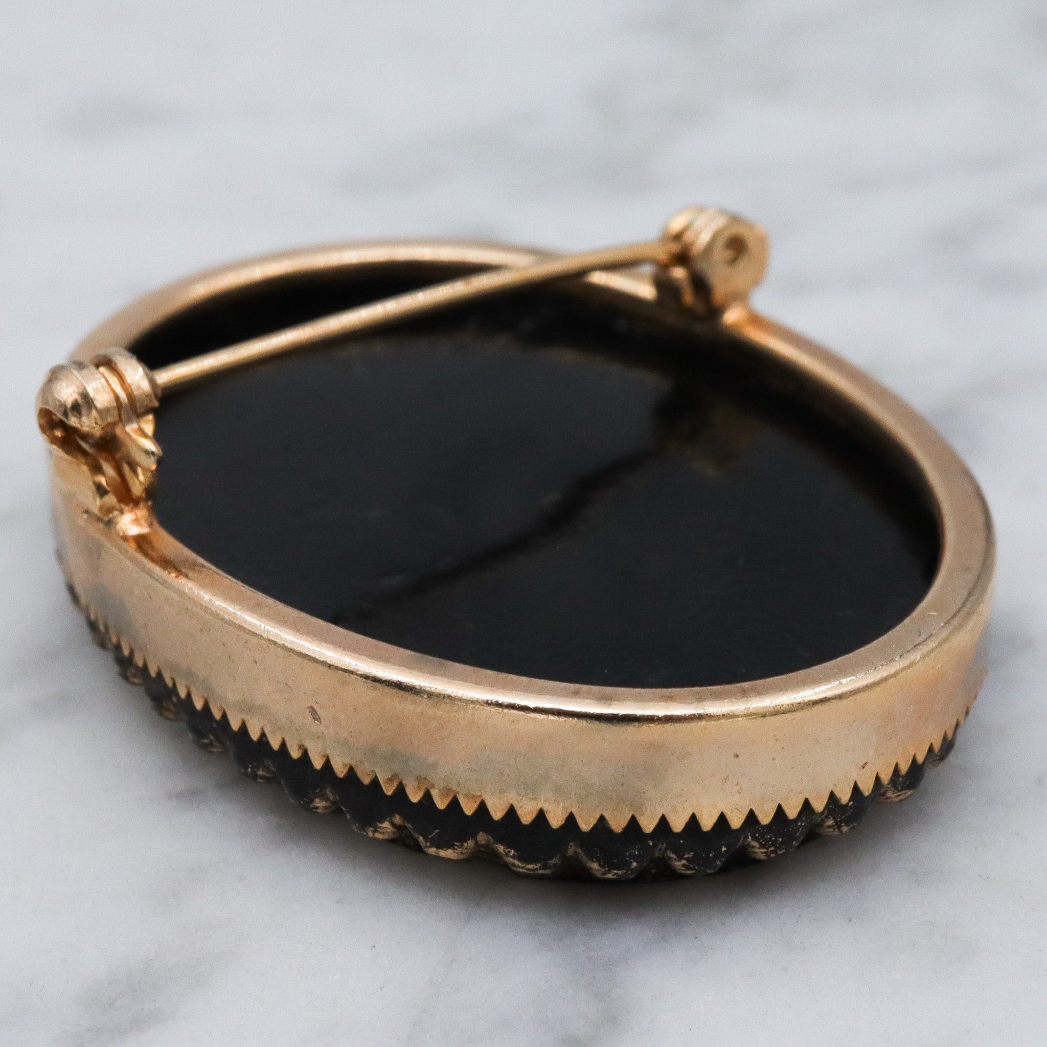 Victorian button style black glass brooch with gold sunburst
