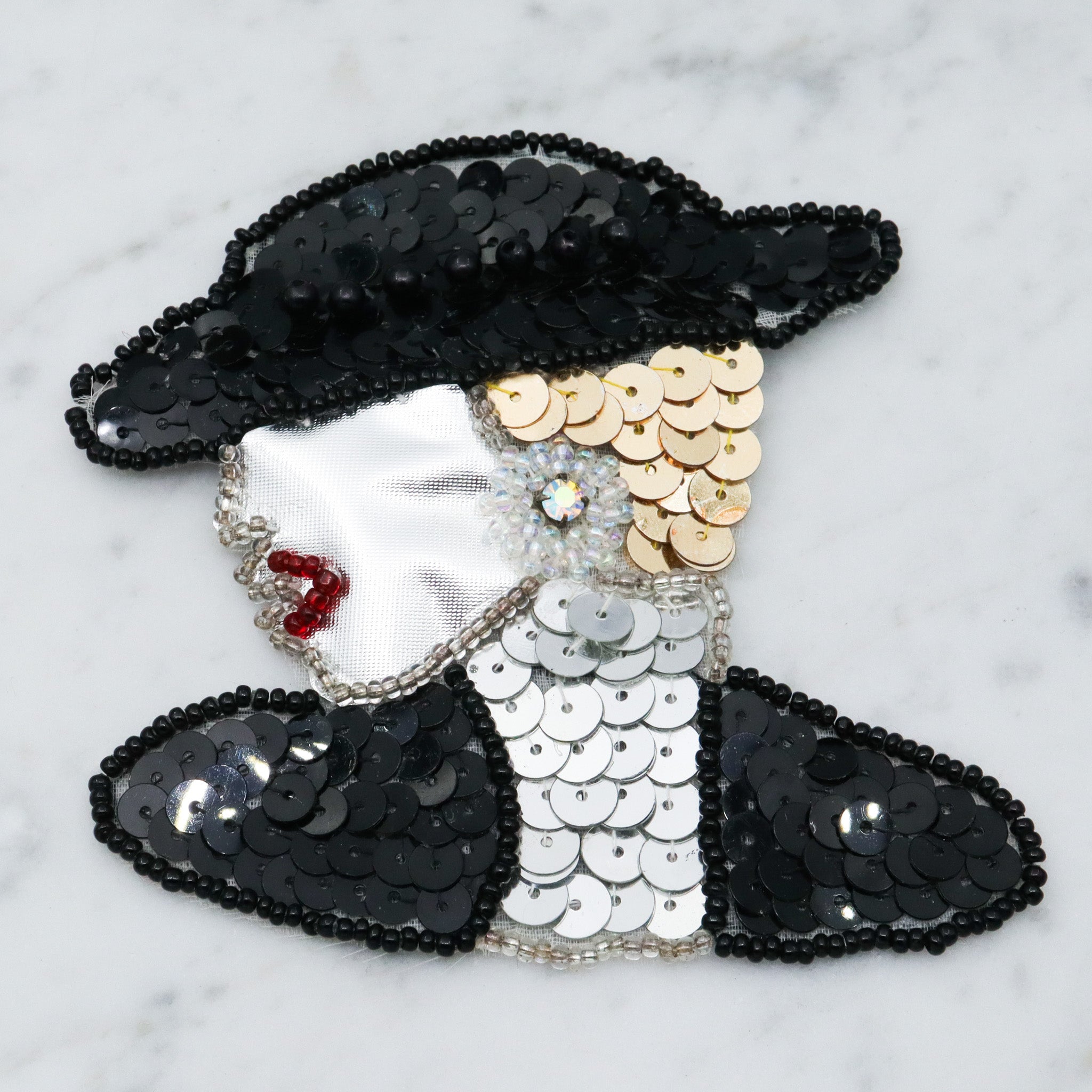 1980's handmade sequin applique brooch of a woman in a black hat