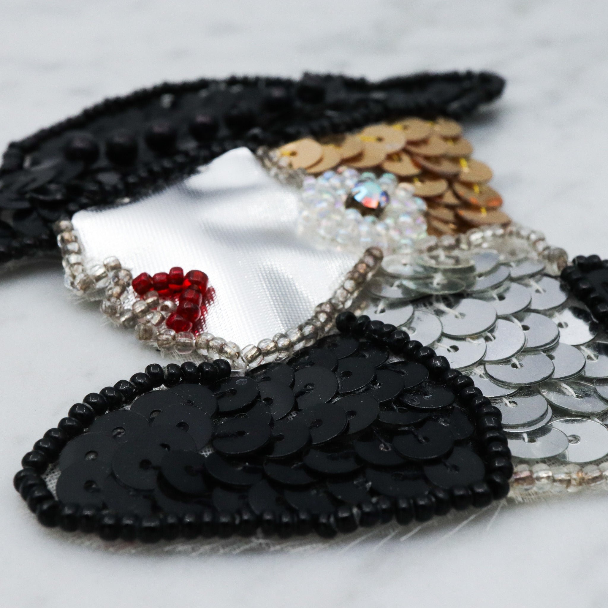 1980's handmade sequin applique brooch of a woman in a black hat