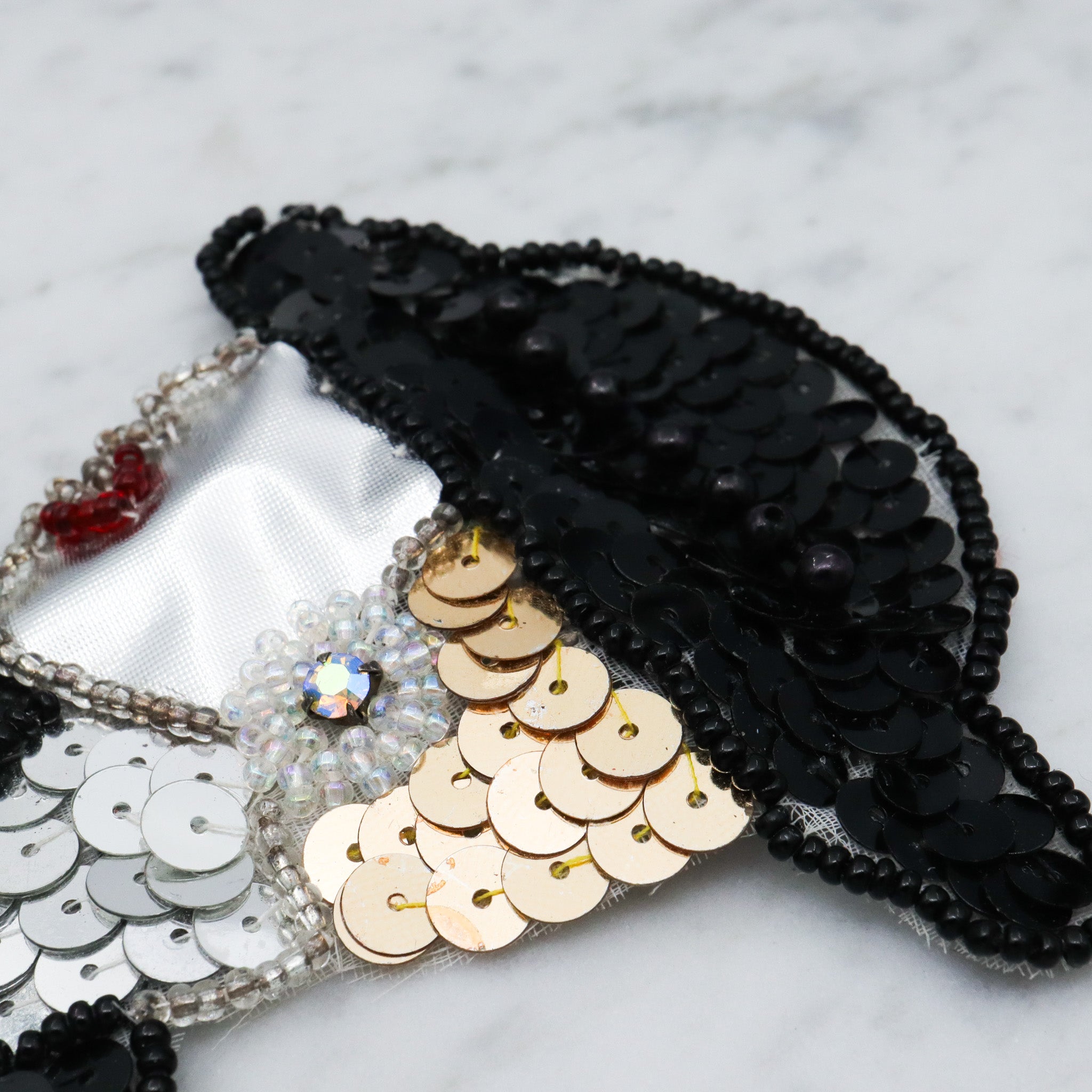 1980's handmade sequin applique brooch of a woman in a black hat