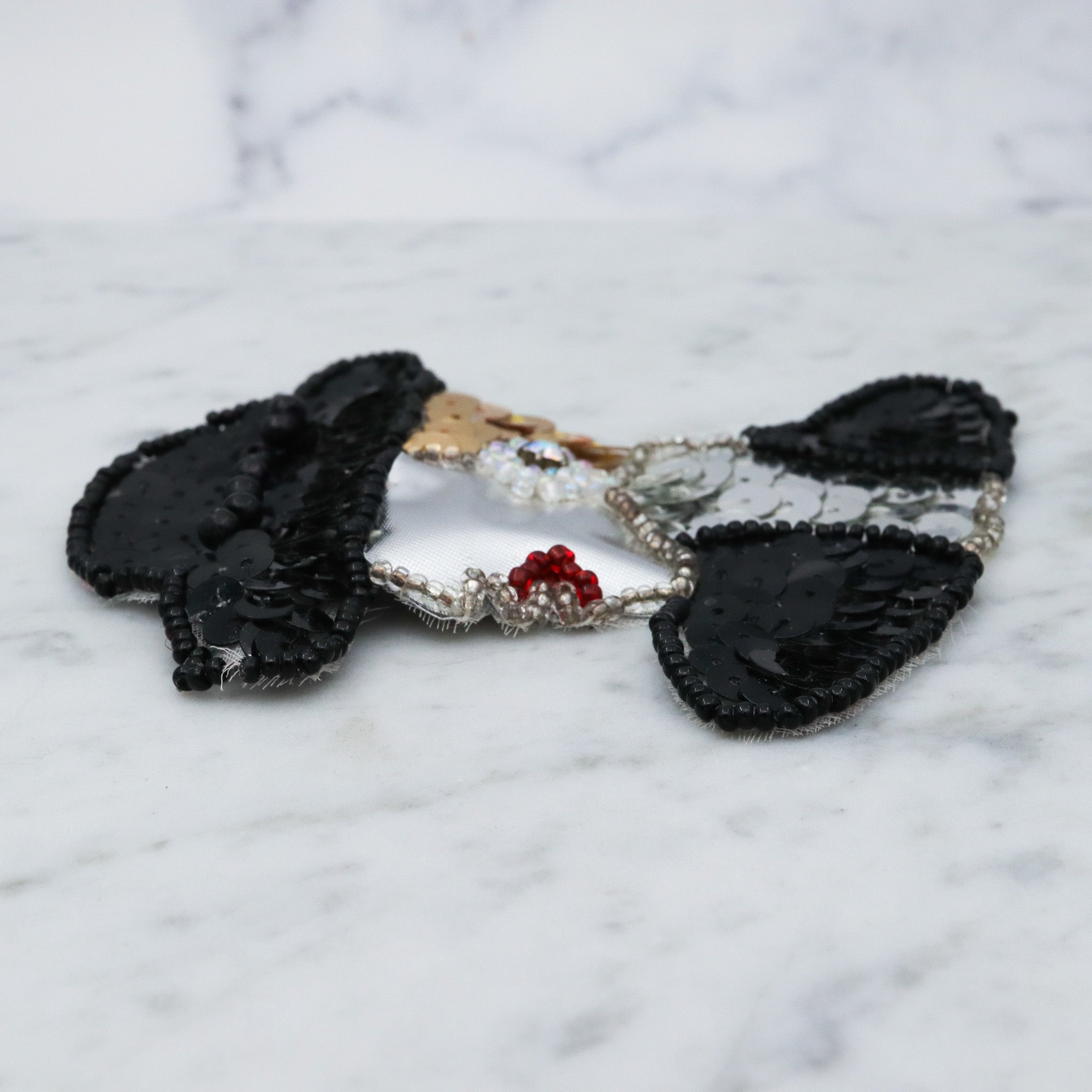 1980's handmade sequin applique brooch of a woman in a black hat