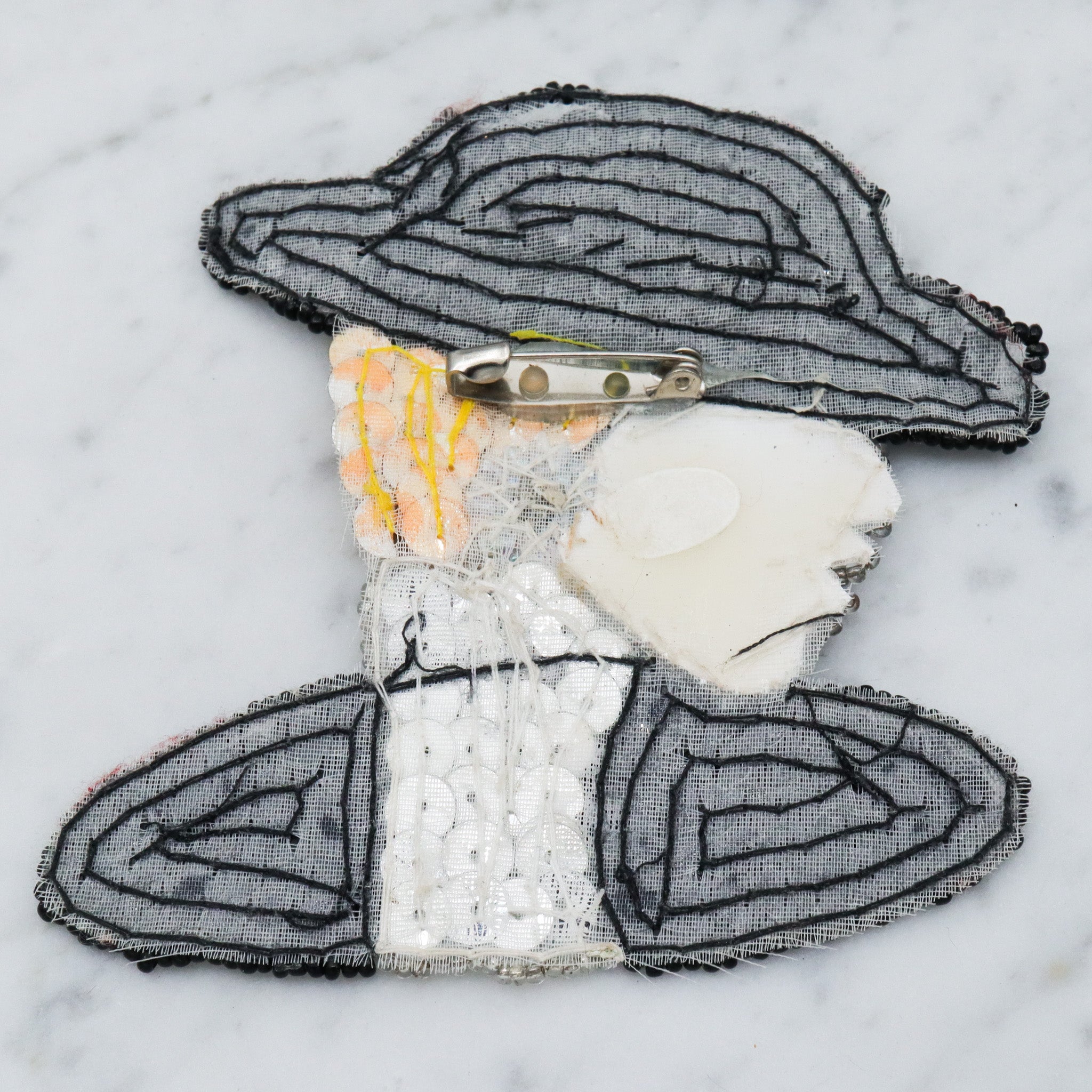 1980's handmade sequin applique brooch of a woman in a black hat