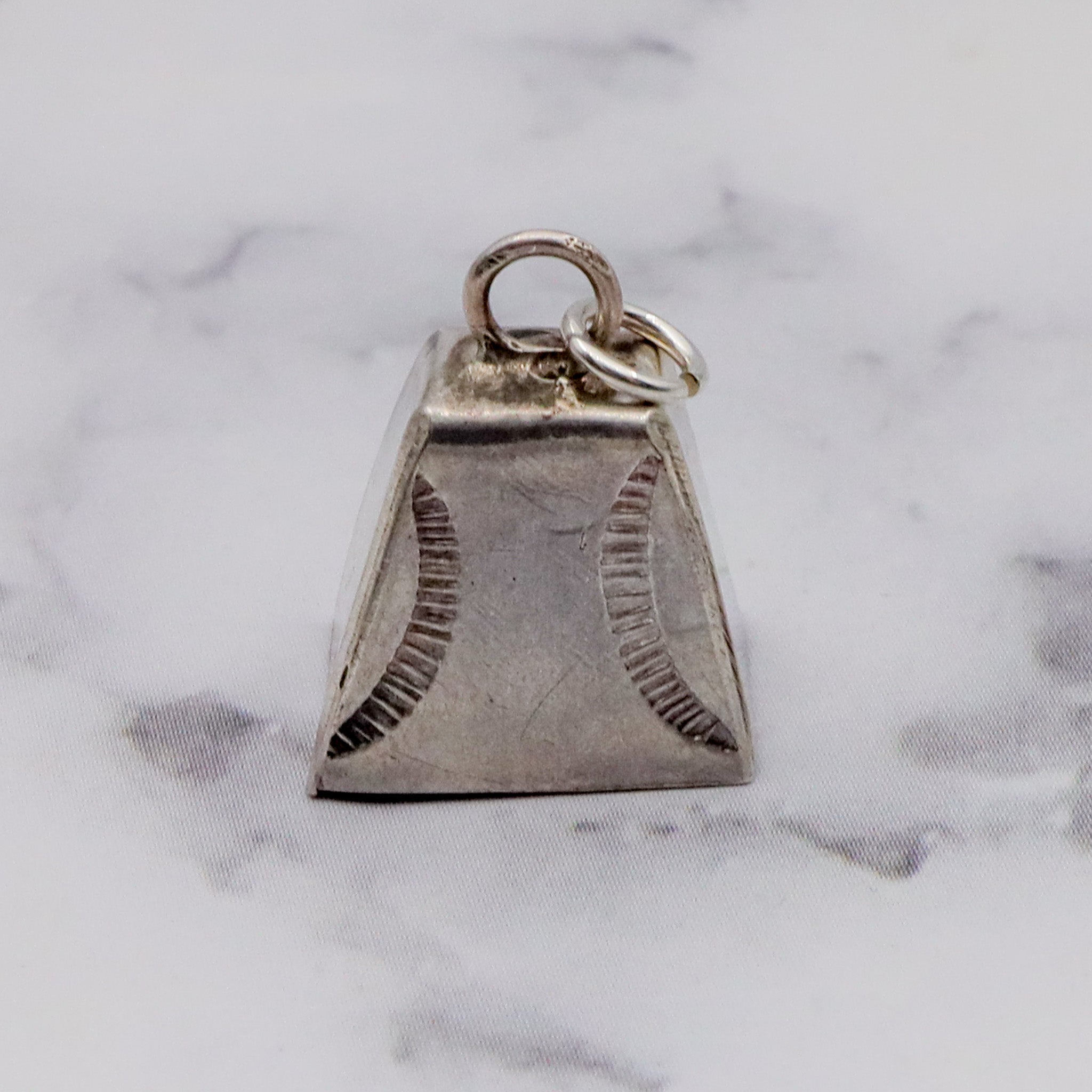Antique handmade Native American sterling stamped cowbell charm