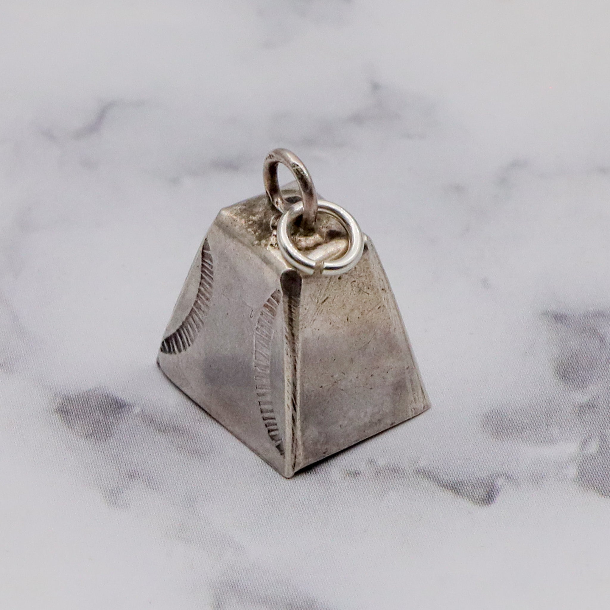 Antique handmade Native American sterling stamped cowbell charm