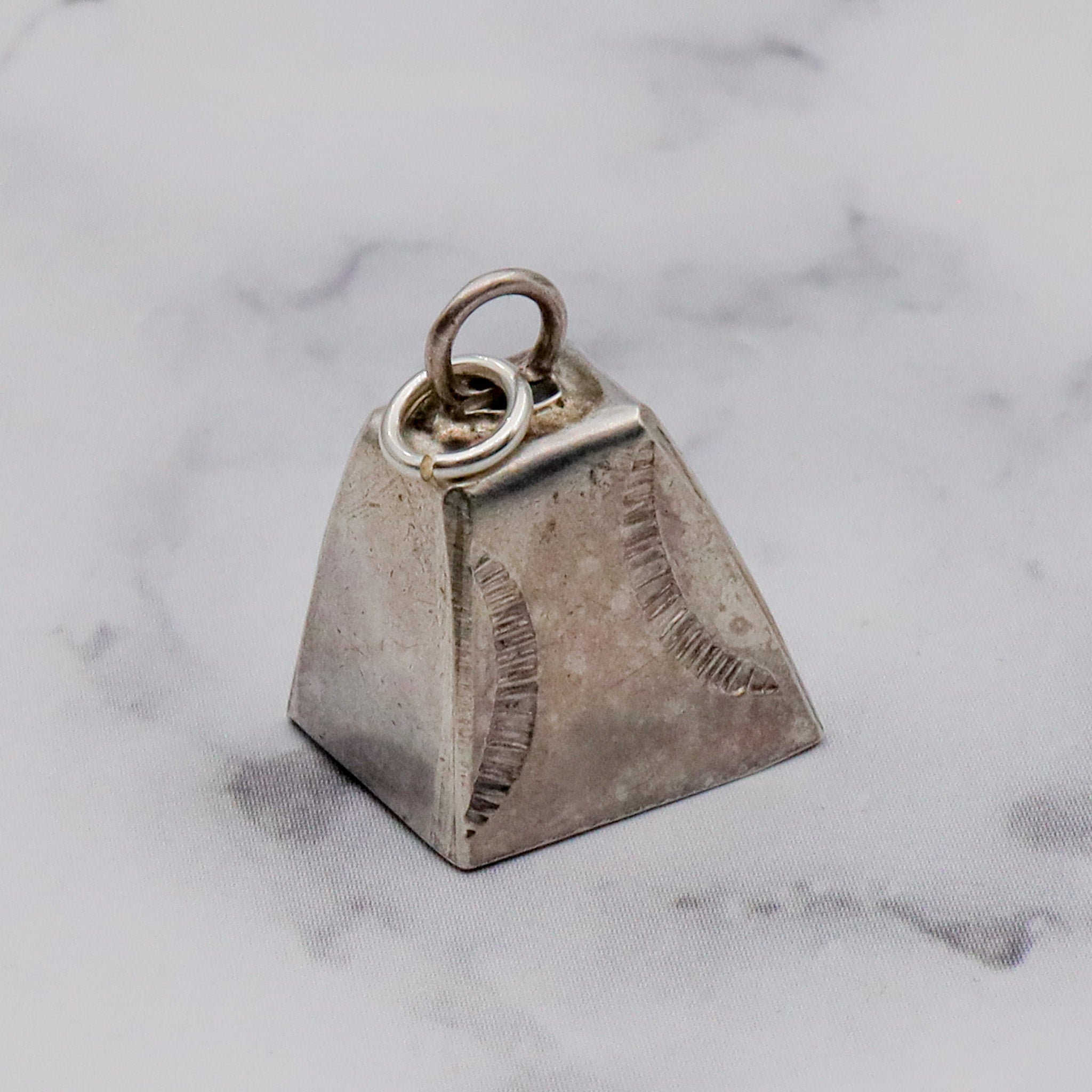 Antique handmade Native American sterling stamped cowbell charm