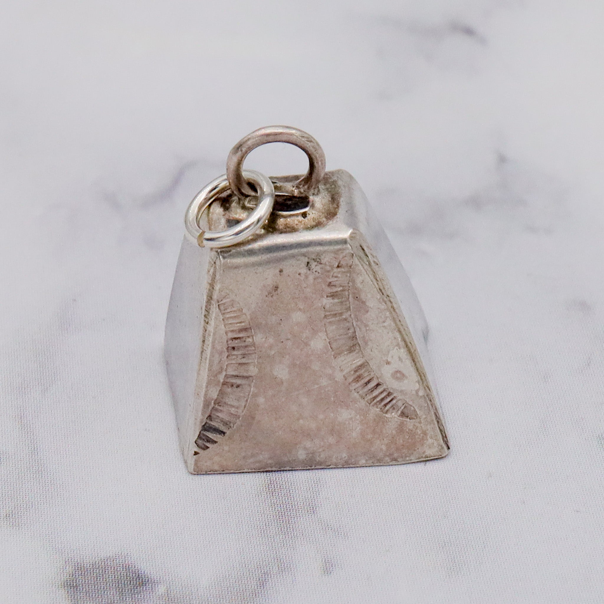 Antique handmade Native American sterling stamped cowbell charm