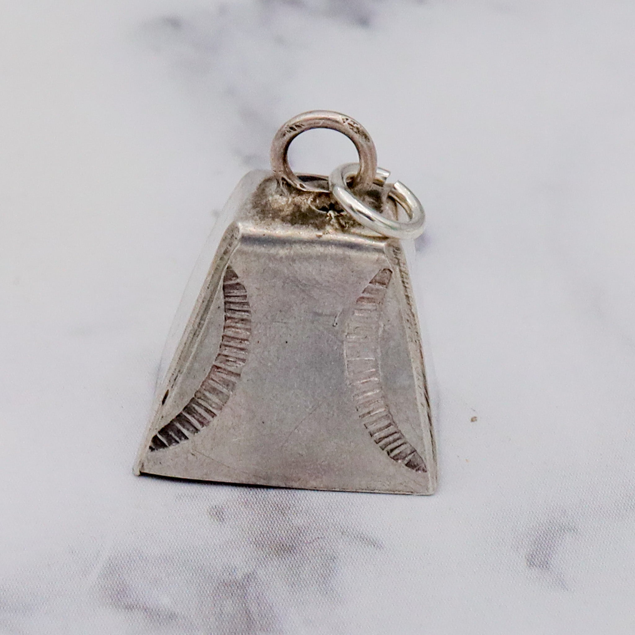 Antique handmade Native American sterling stamped cowbell charm