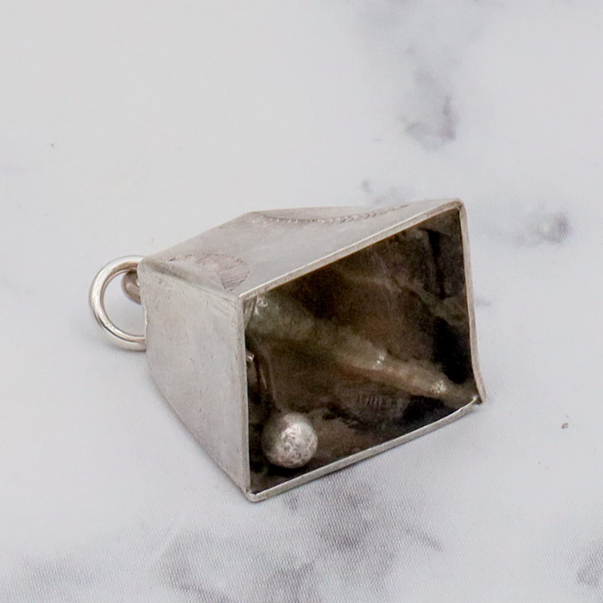 Antique handmade Native American sterling stamped cowbell charm