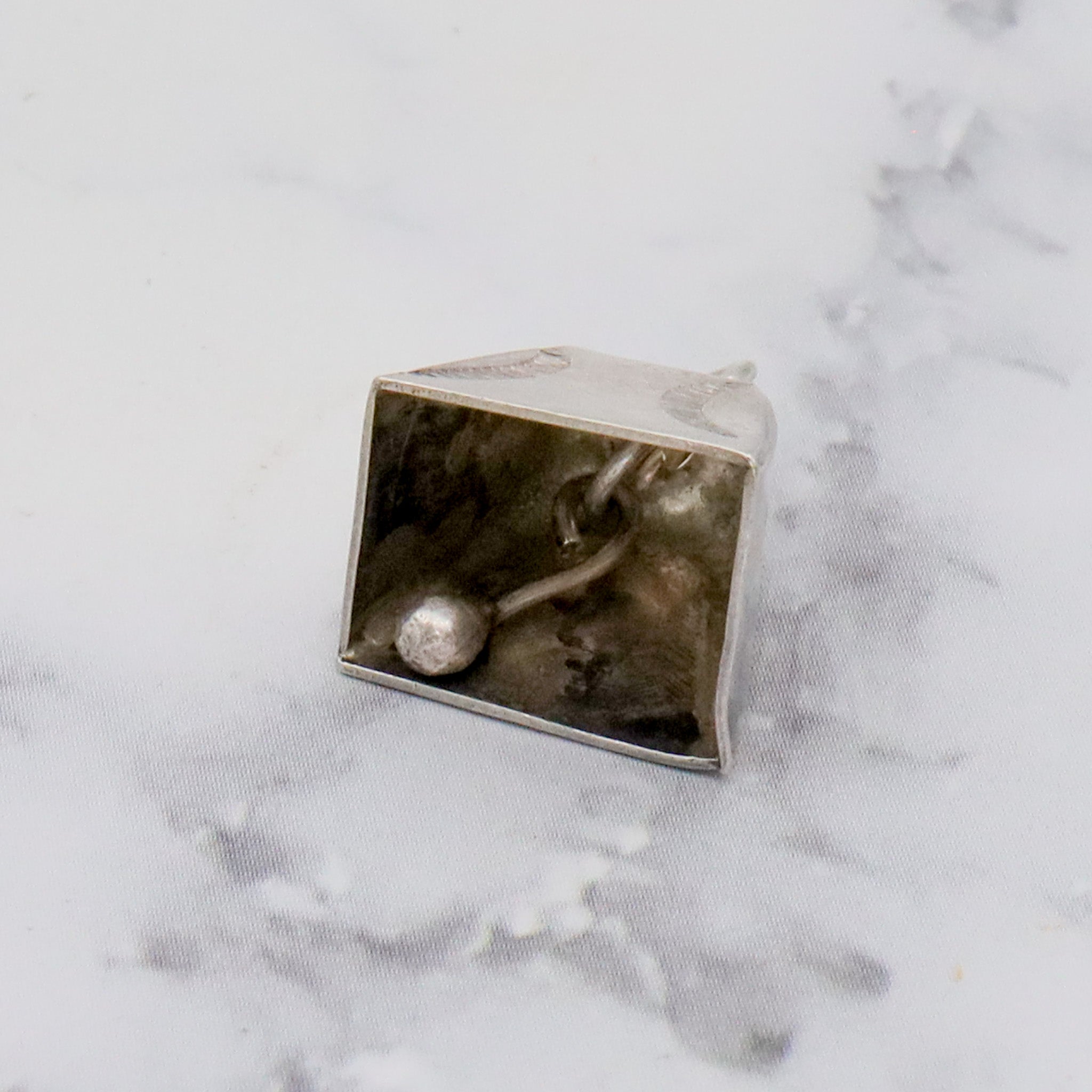 Antique handmade Native American sterling stamped cowbell charm