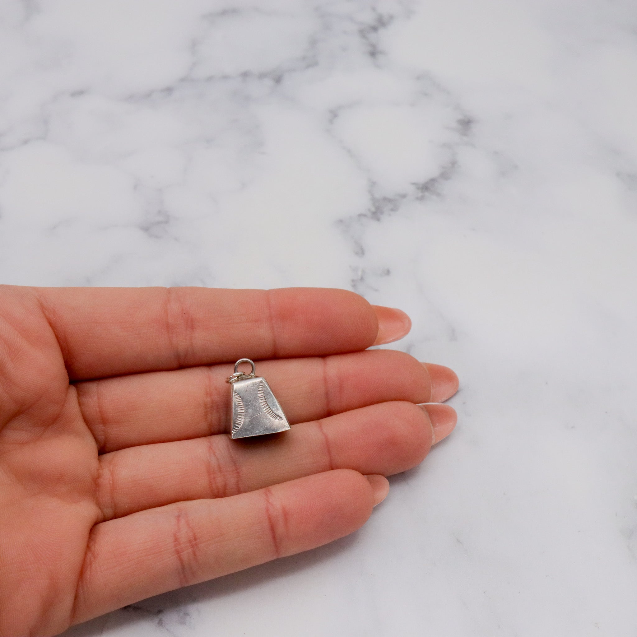 Antique handmade Native American sterling stamped cowbell charm