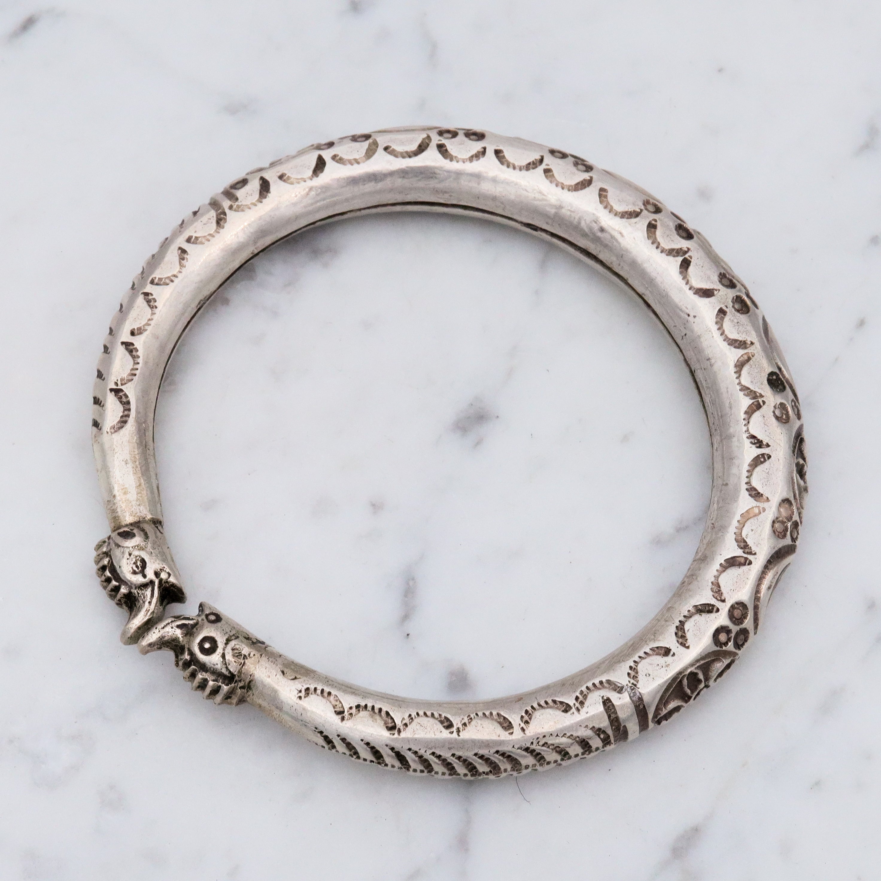 Vintage tribal stamped sterling hollow elephant head bangle