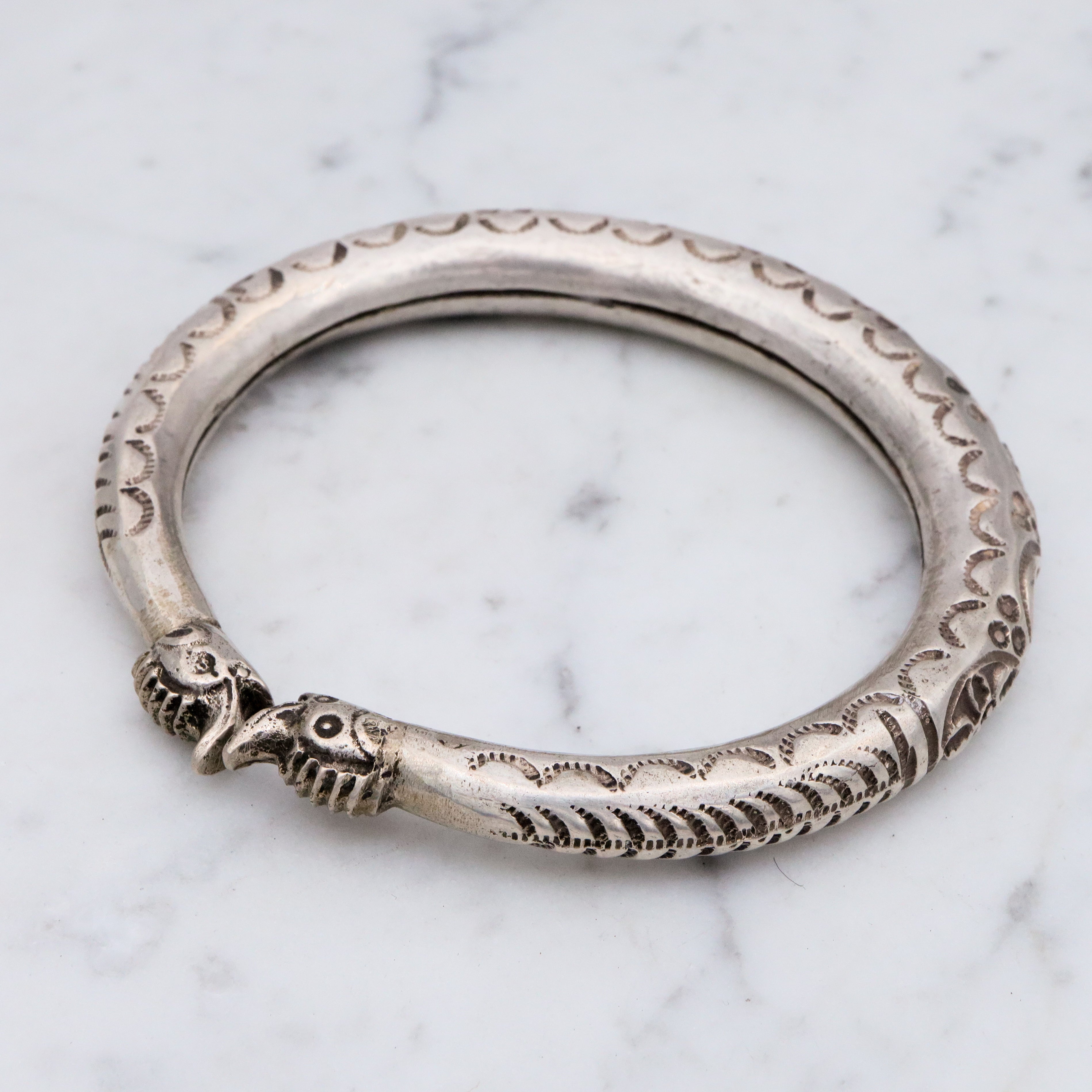 Vintage tribal stamped sterling hollow elephant head bangle