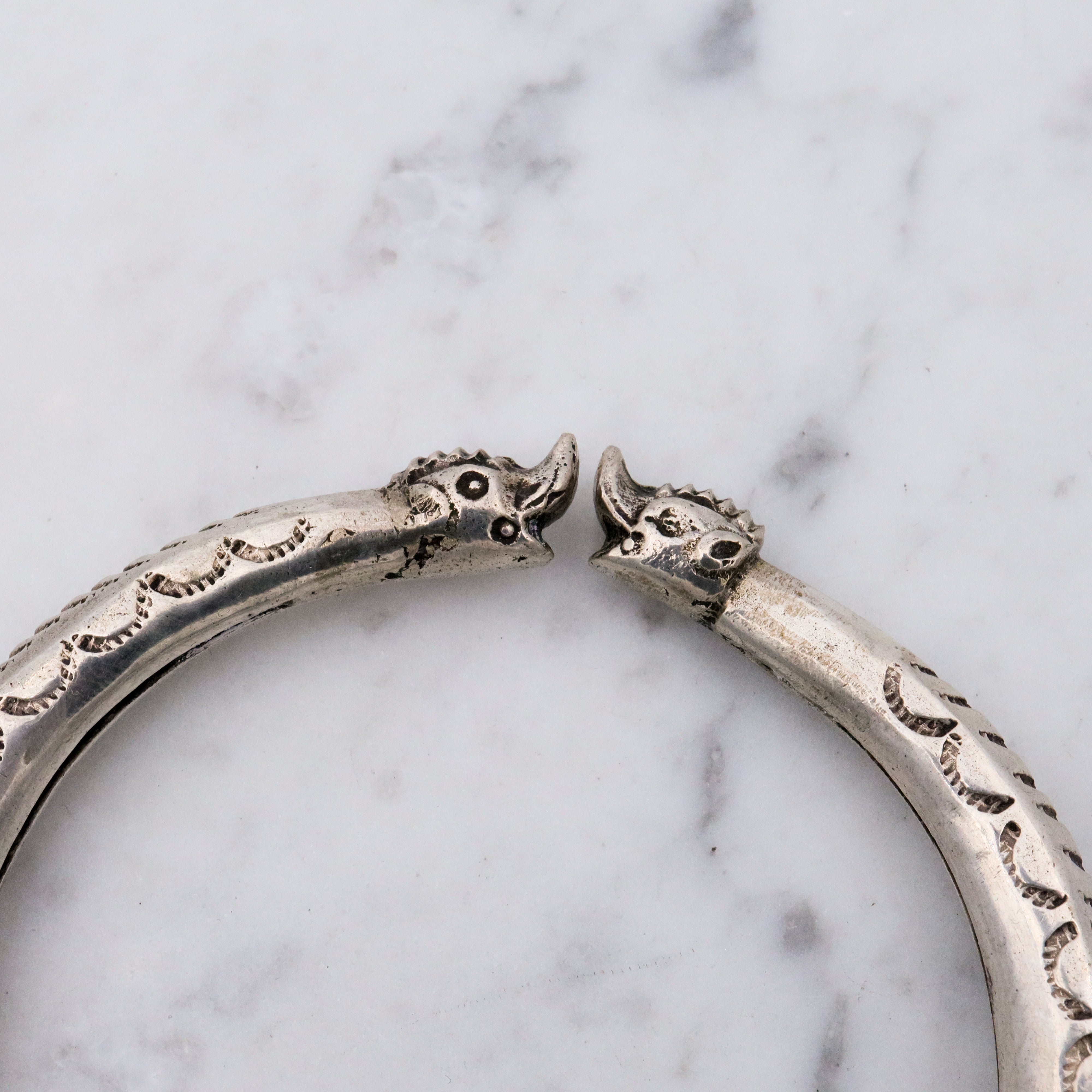 Vintage tribal stamped sterling hollow elephant head bangle