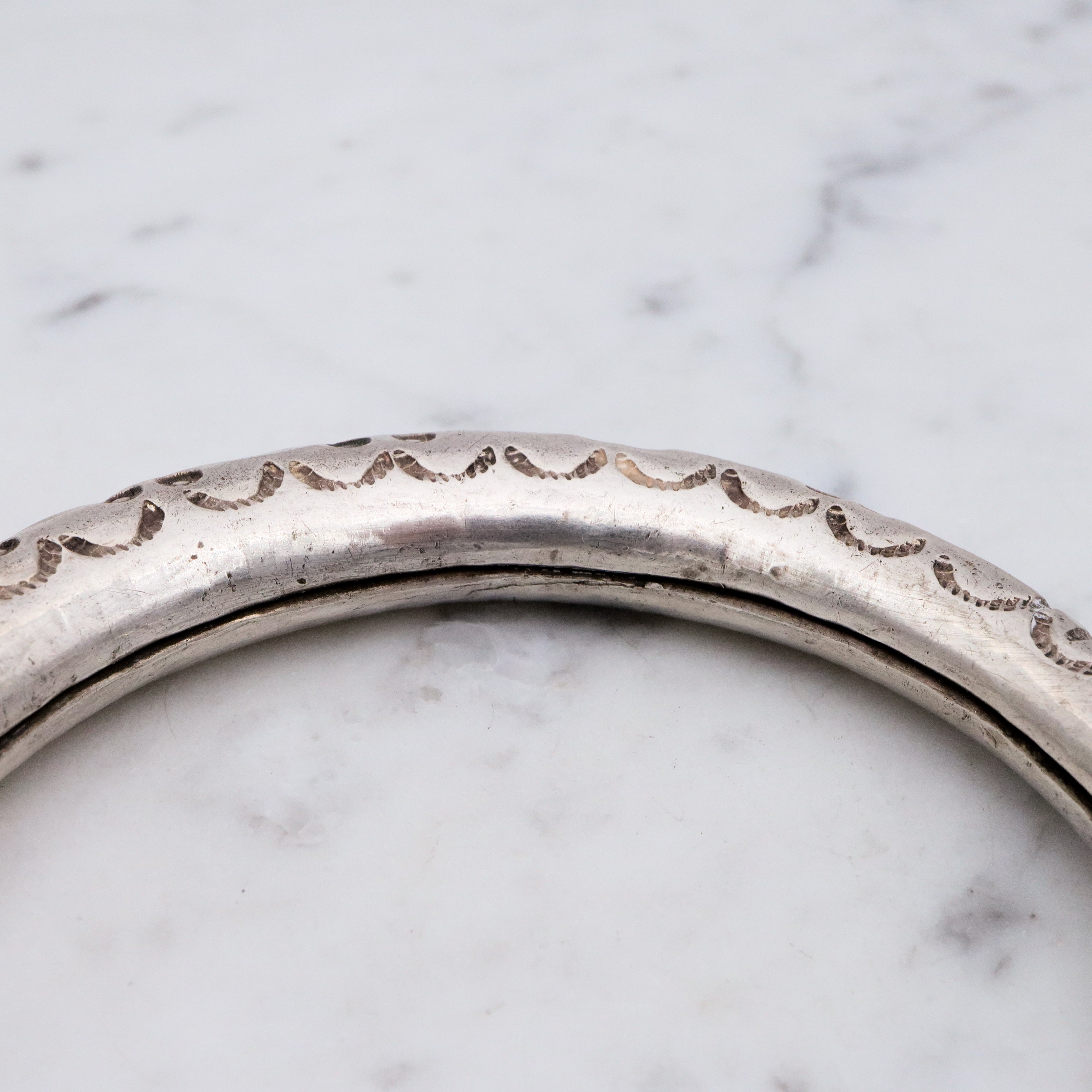 Vintage tribal stamped sterling hollow elephant head bangle