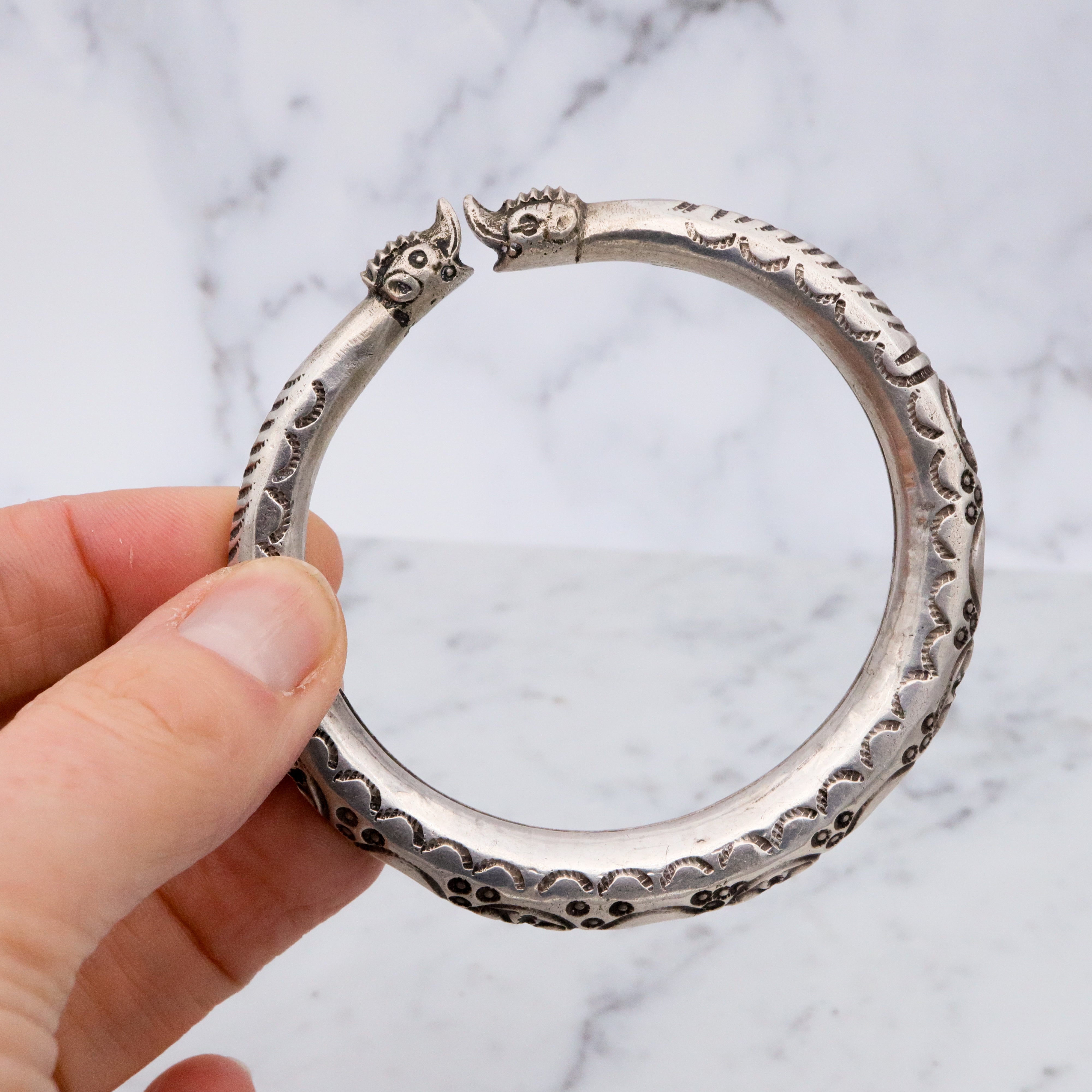 Vintage tribal stamped sterling hollow elephant head bangle
