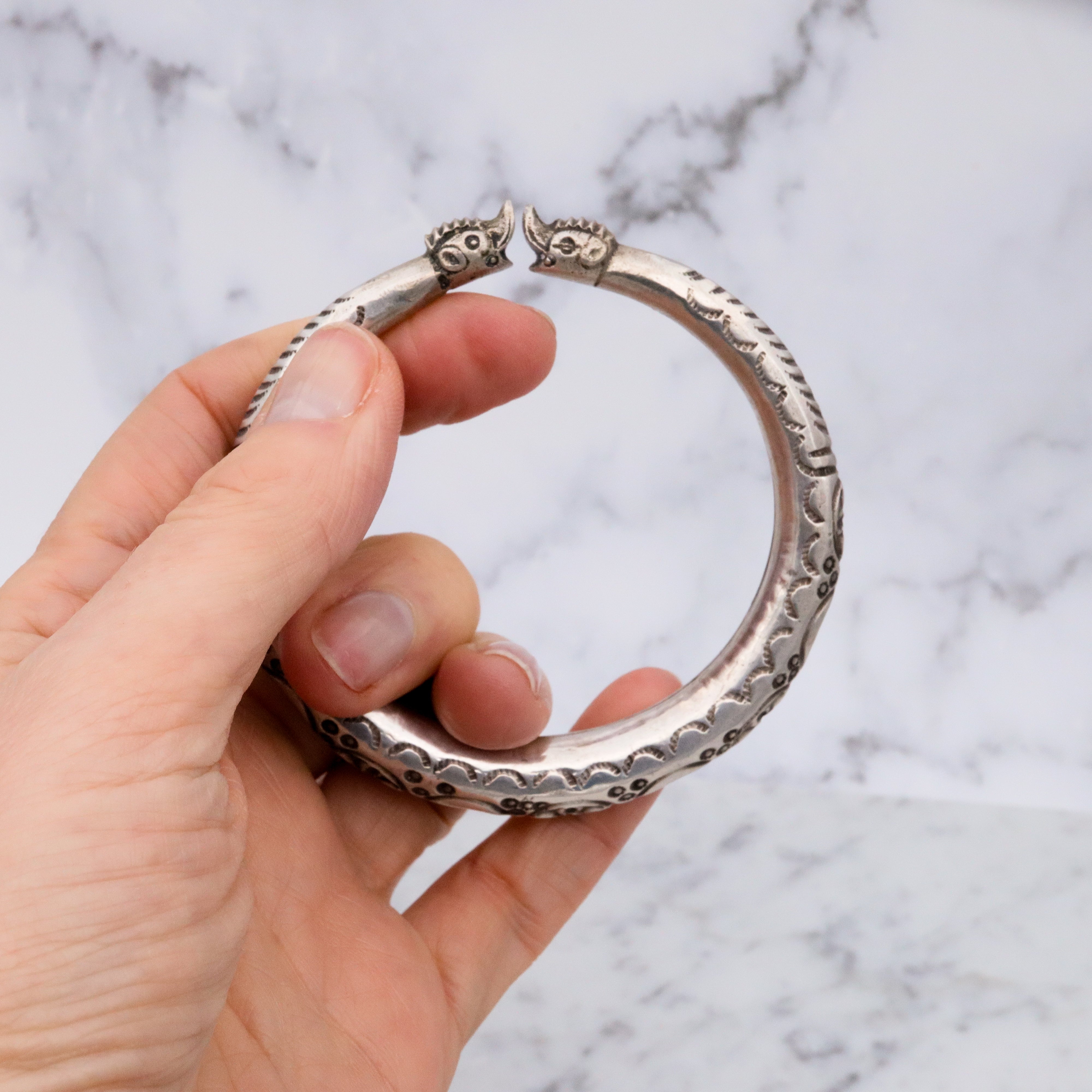 Vintage tribal stamped sterling hollow elephant head bangle