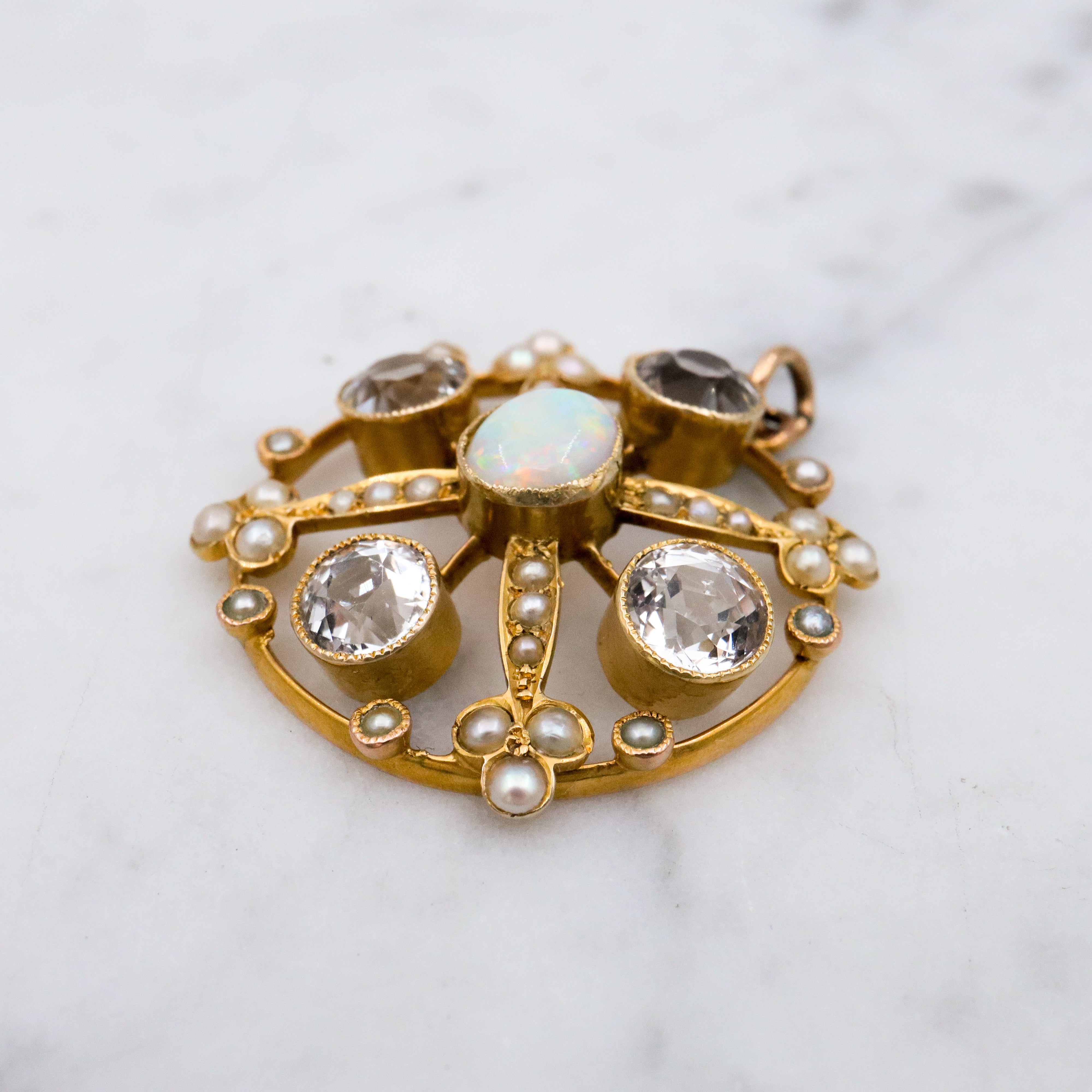 Antique Belle Epoque opal, white topaz, & pearl 9k gold circle pendant
