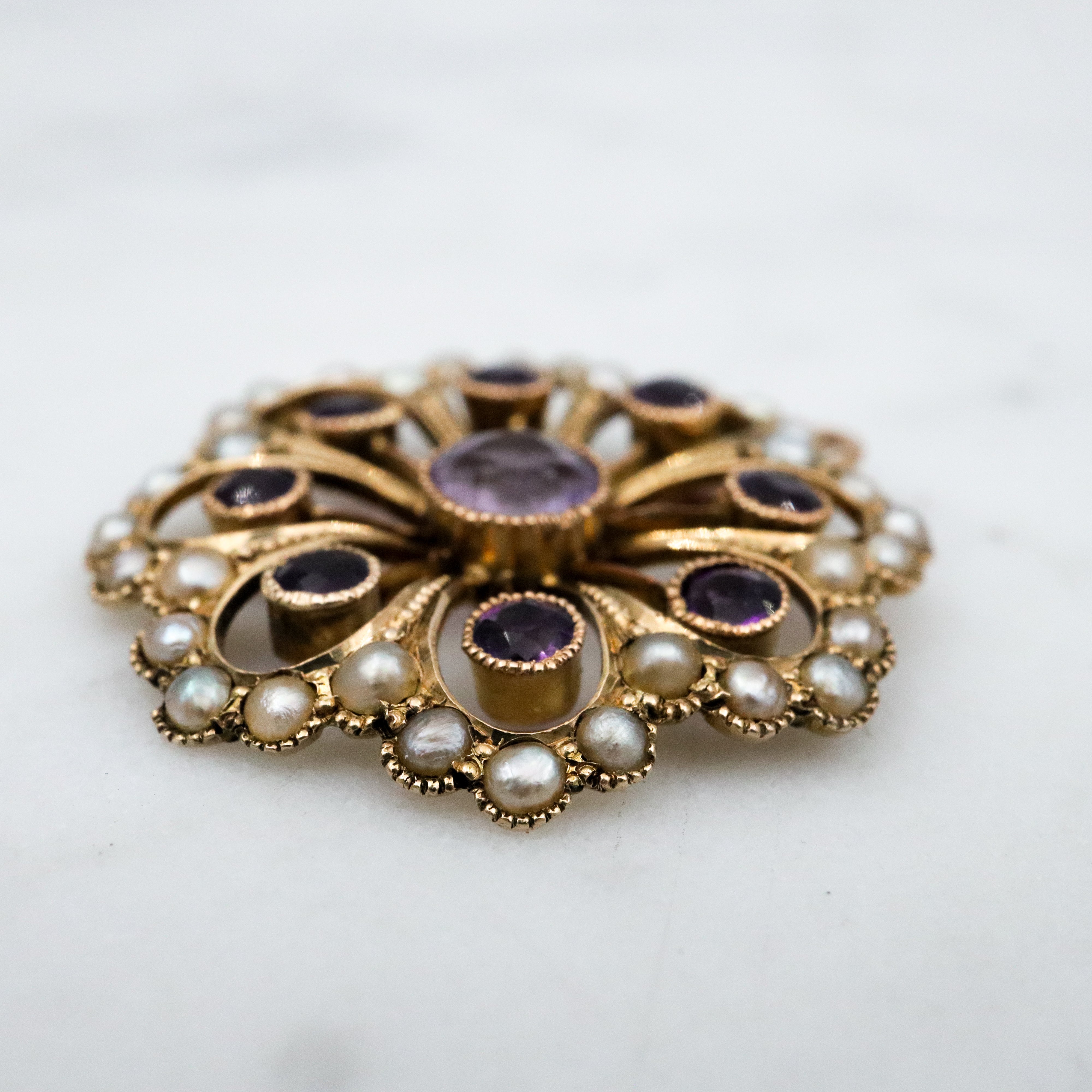 Antique early Victorian 9k gold, amethyst and split pearl flower pendant