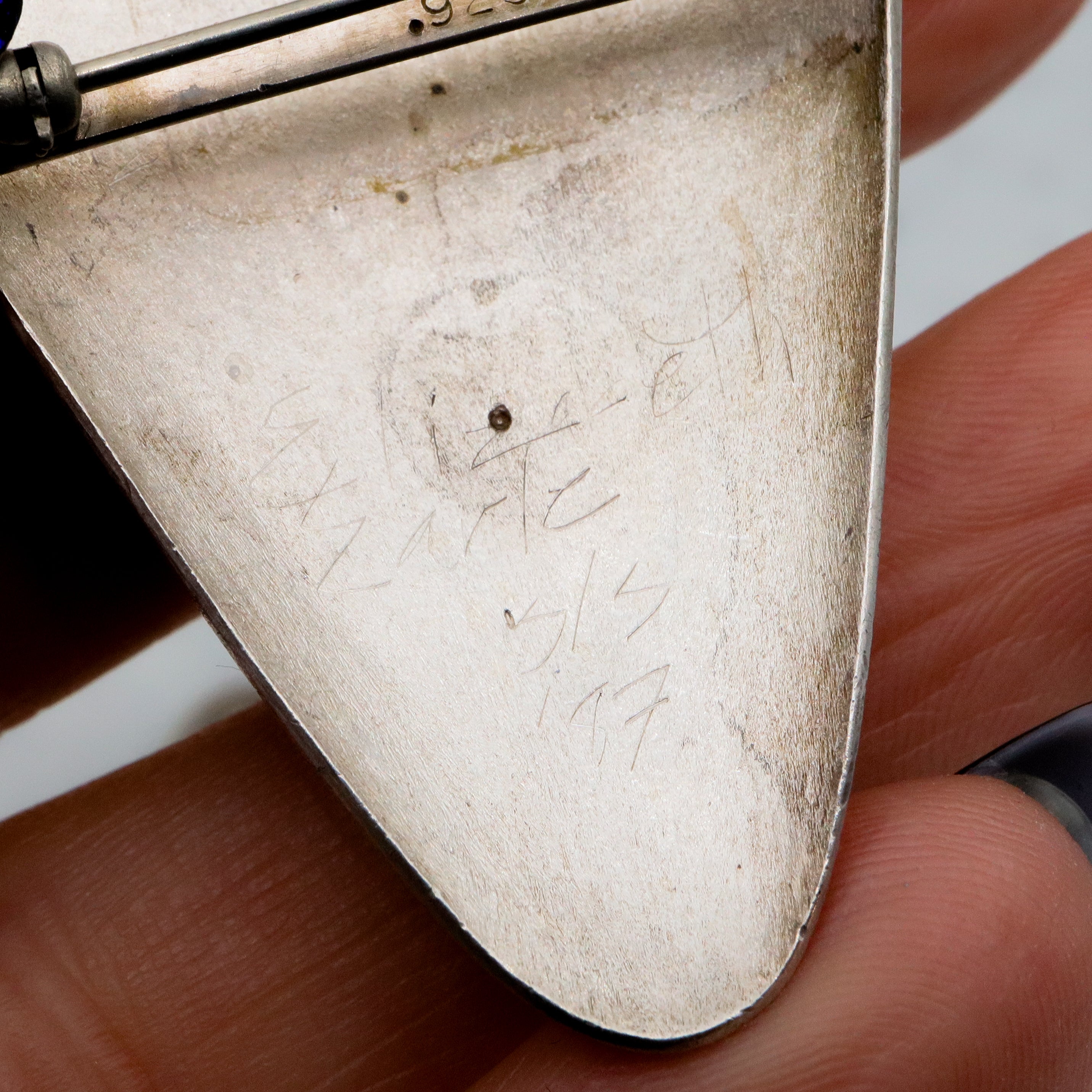 1987 pair of brushed sterling mask brooches by Modernist artist Elizabeth Earle