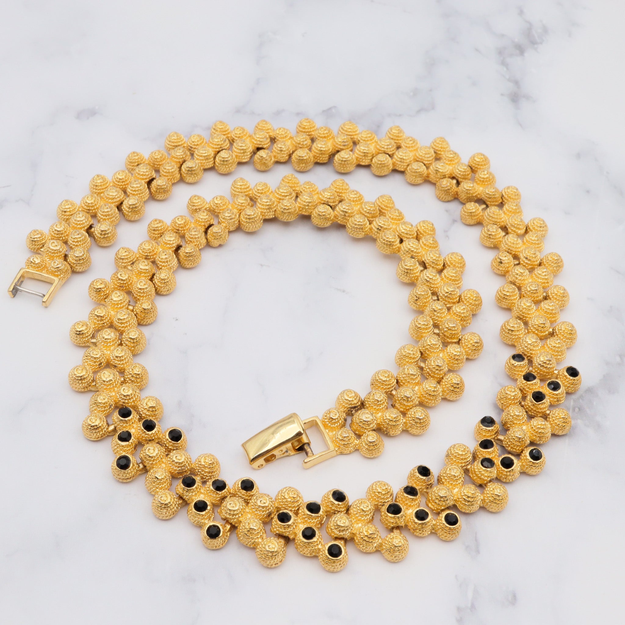 Vintage gold plated textured attached bead necklace with black glass tips