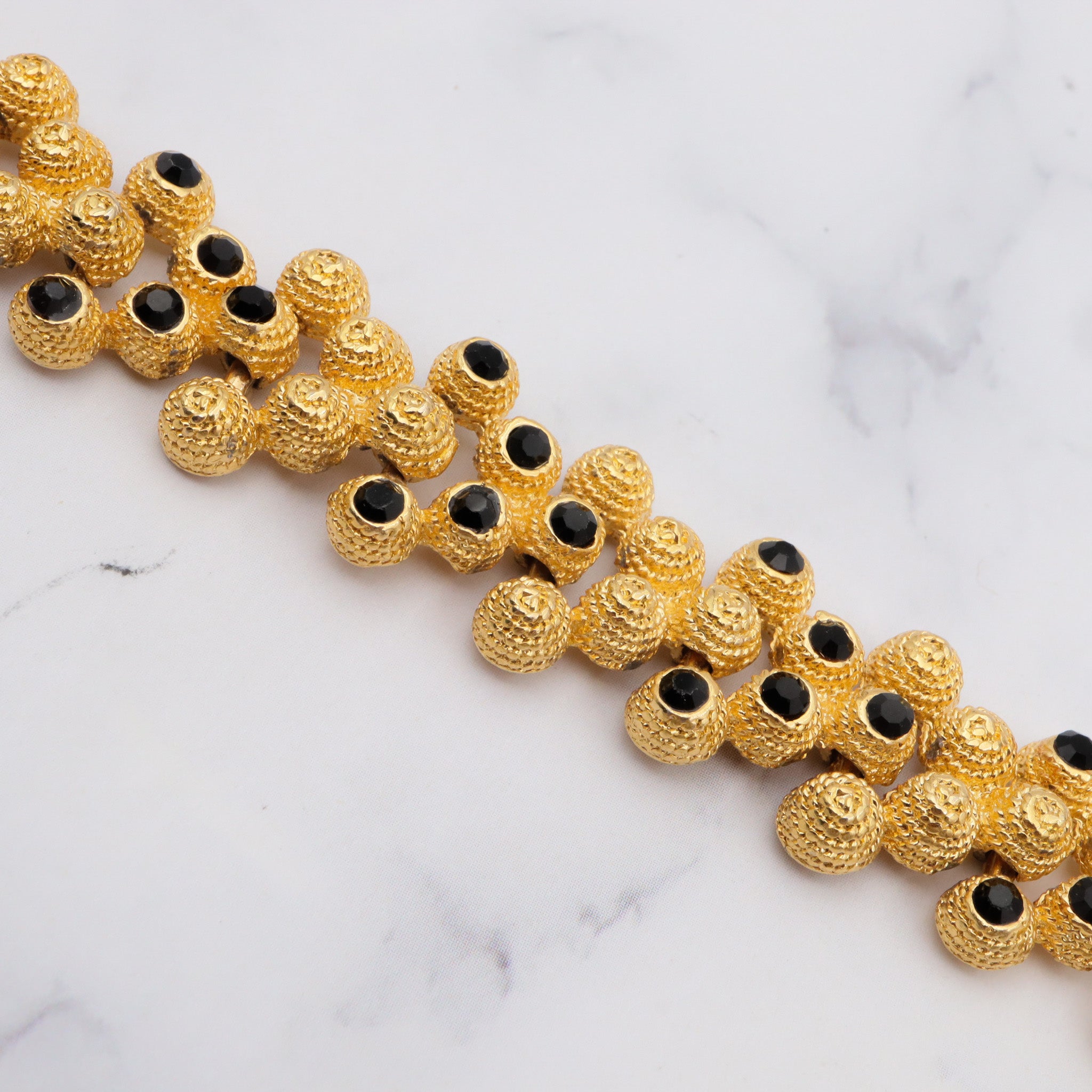 Vintage gold plated textured attached bead necklace with black glass tips