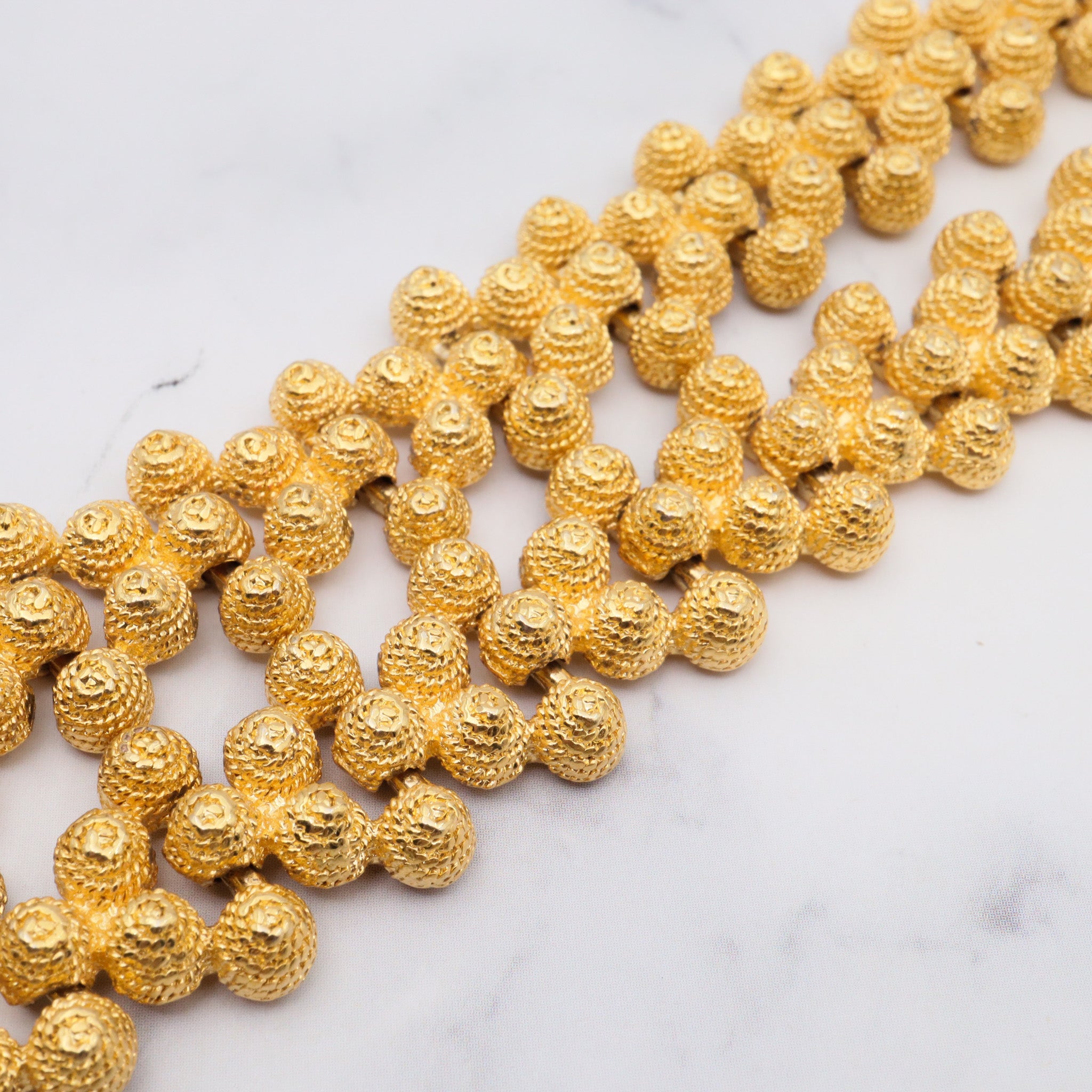 Vintage gold plated textured attached bead necklace with black glass tips