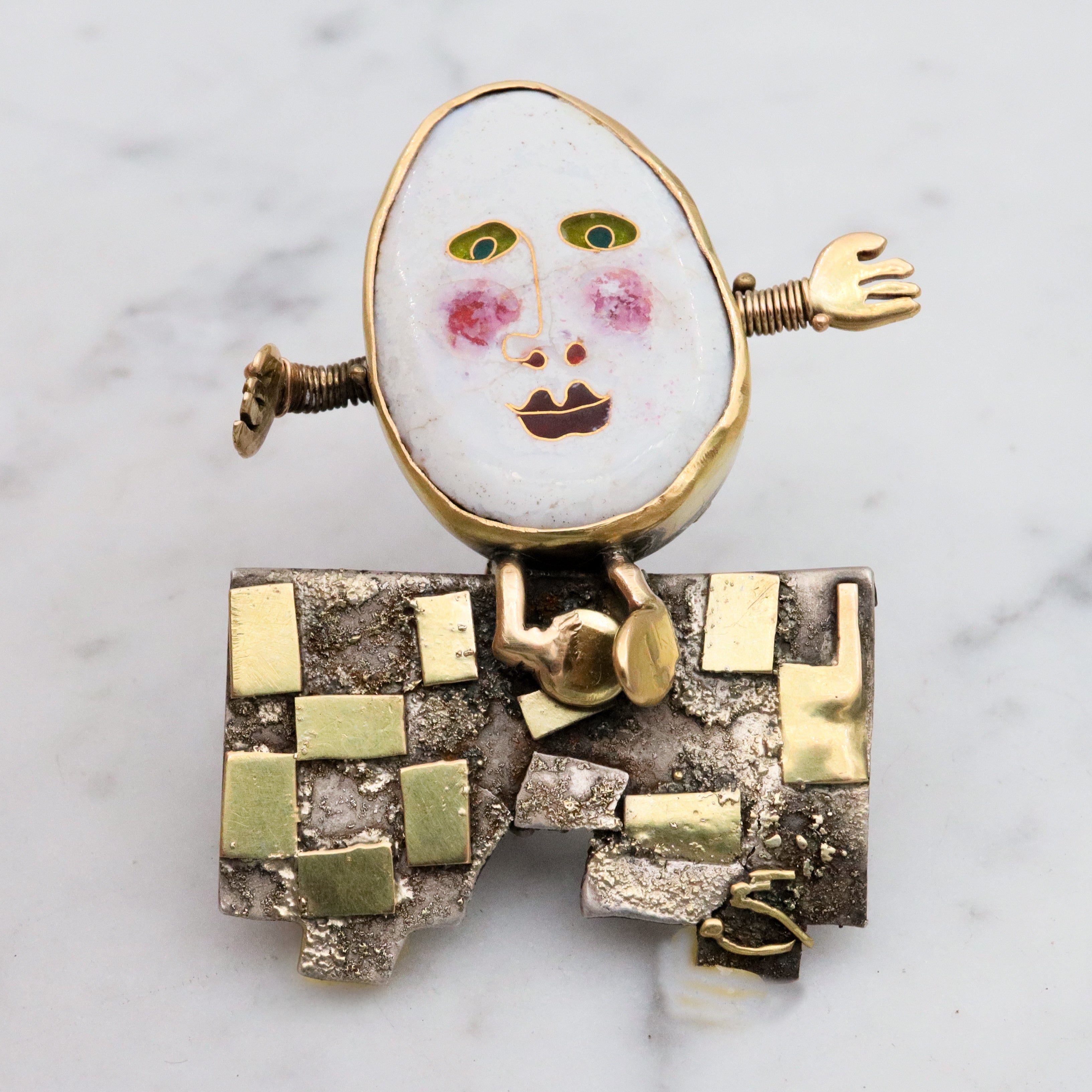 Incredible Avant-garde gold plated sterling & ceramic egg face sitting on wall brooch