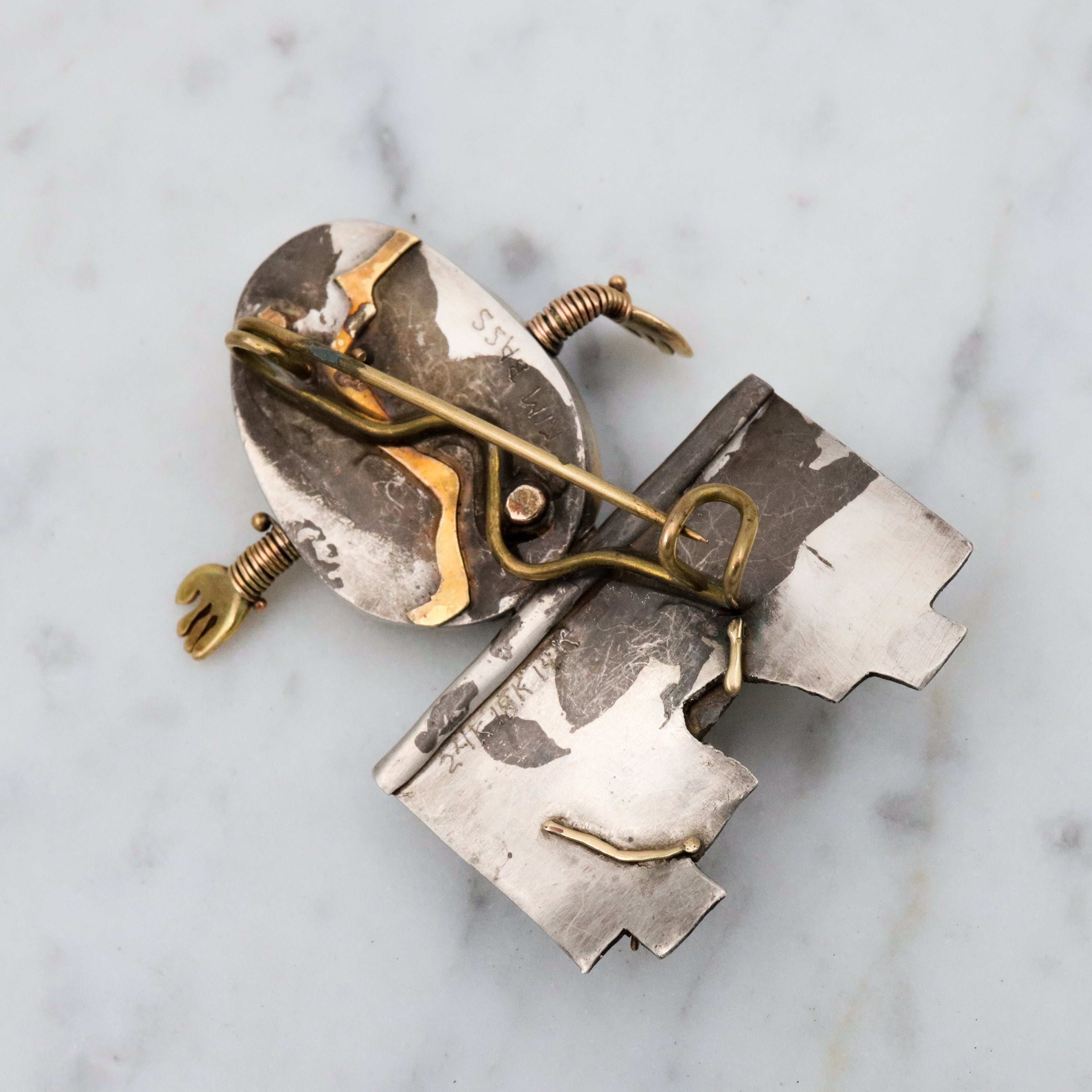 Incredible Avant-garde gold plated sterling & ceramic egg face sitting on wall brooch