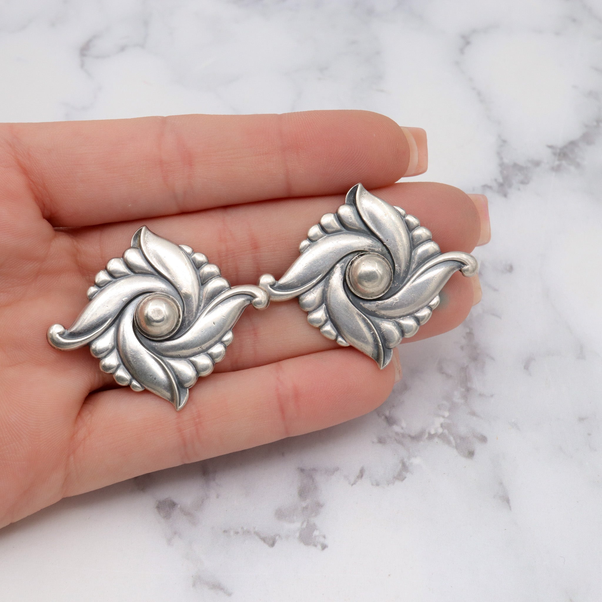 Pair of vintage Carl Ruopoli Mid-Century sterling swirl pins