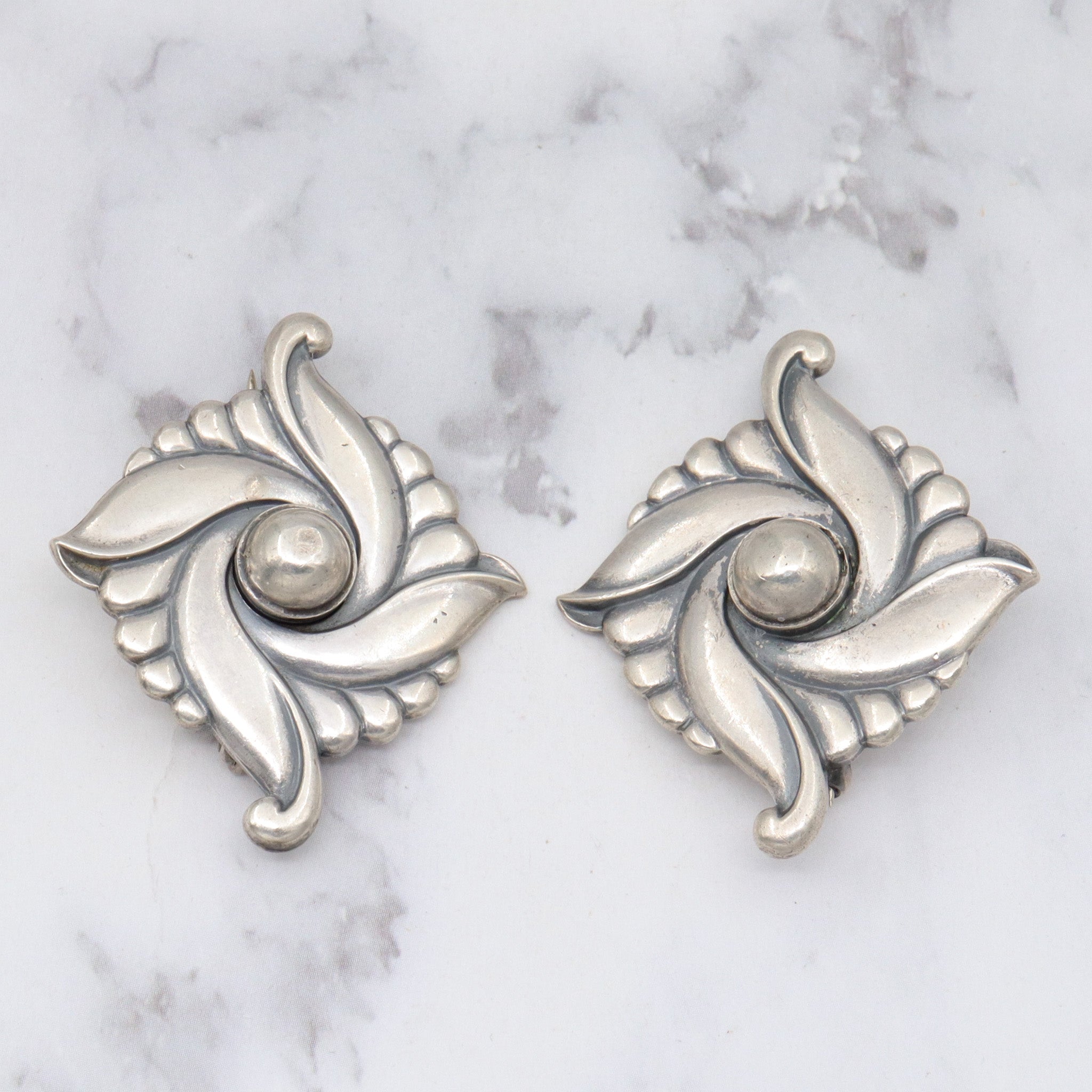 Pair of vintage Carl Ruopoli Mid-Century sterling swirl pins