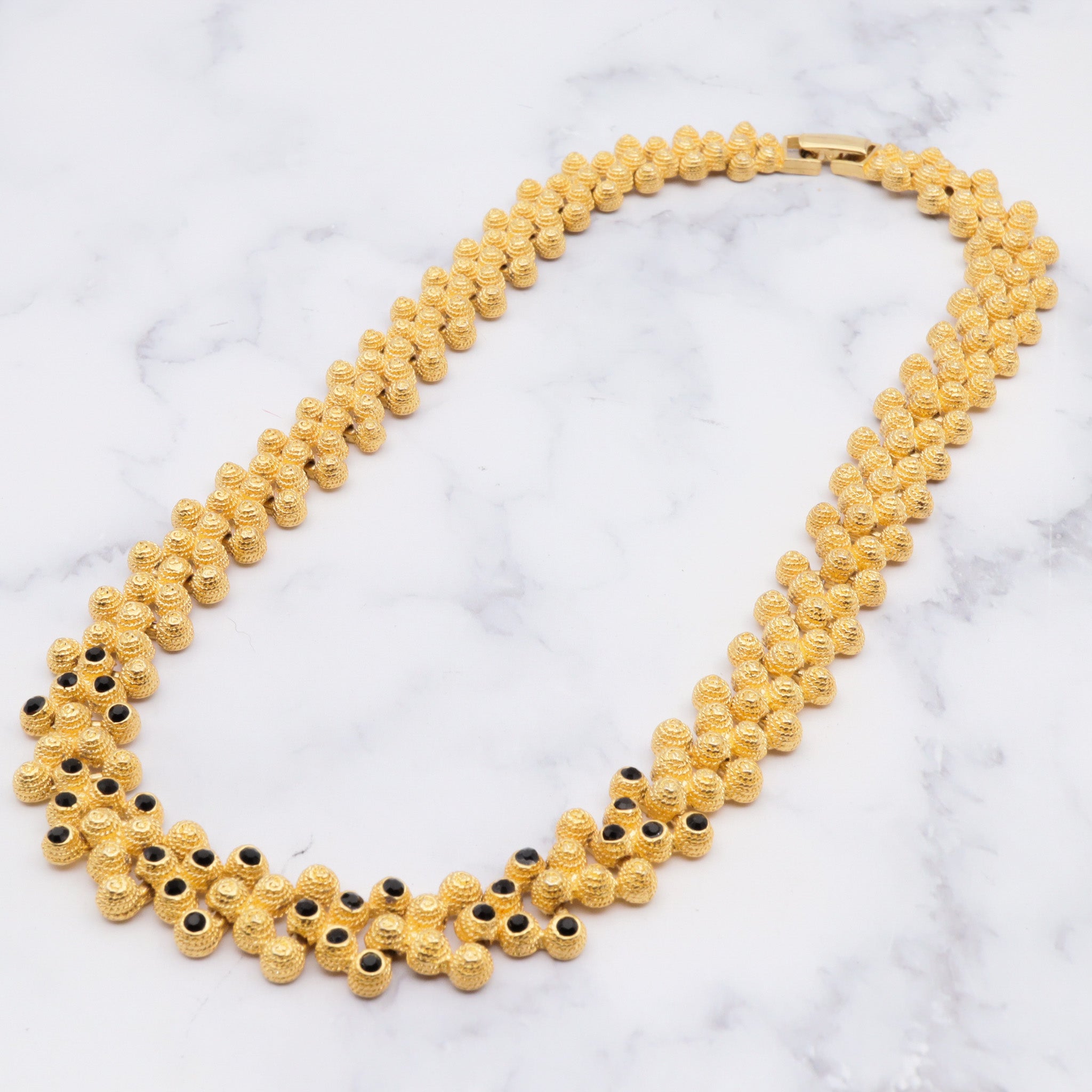 Vintage gold plated textured attached bead necklace with black glass tips