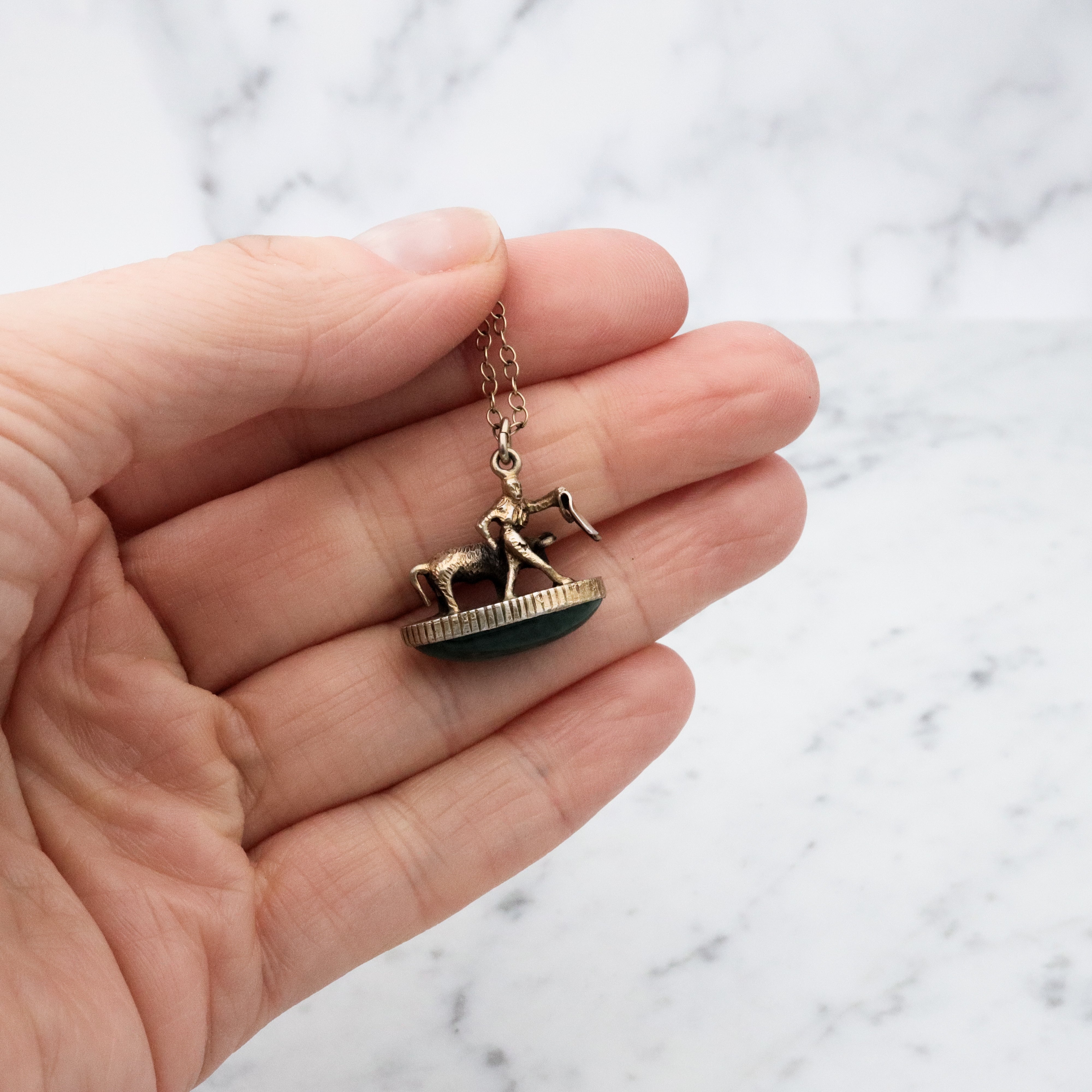 Antique gilt sterling figural matador & bull fob pendant w/faux bloodstone bottom
