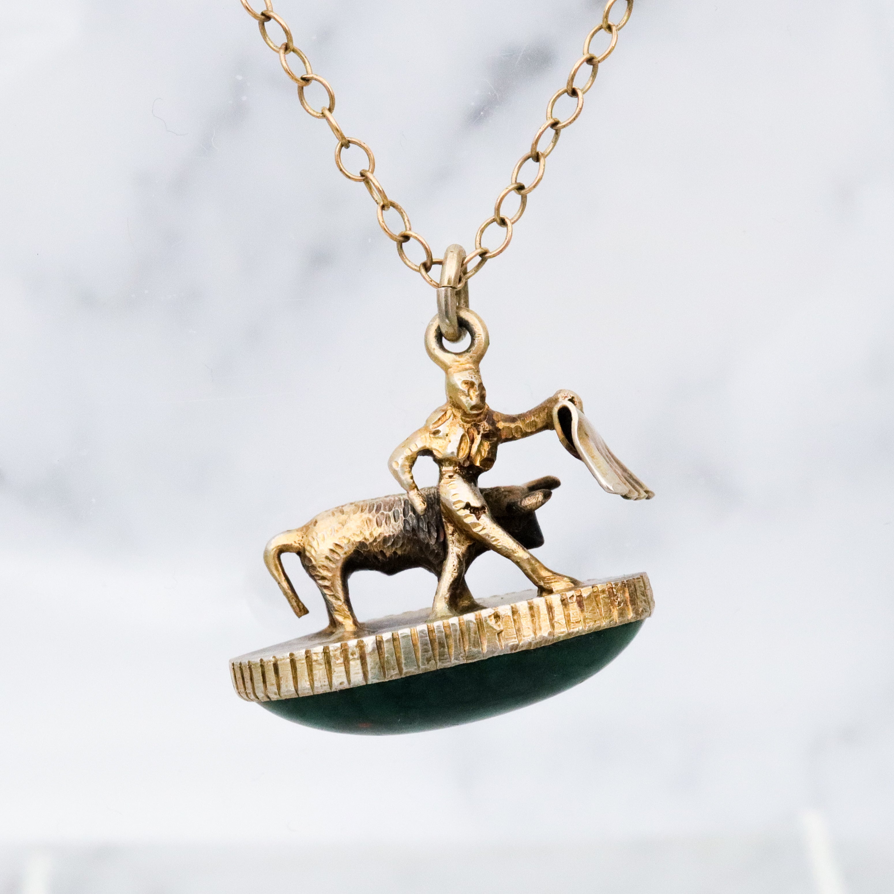 Antique gilt sterling figural matador & bull fob pendant w/faux bloodstone bottom